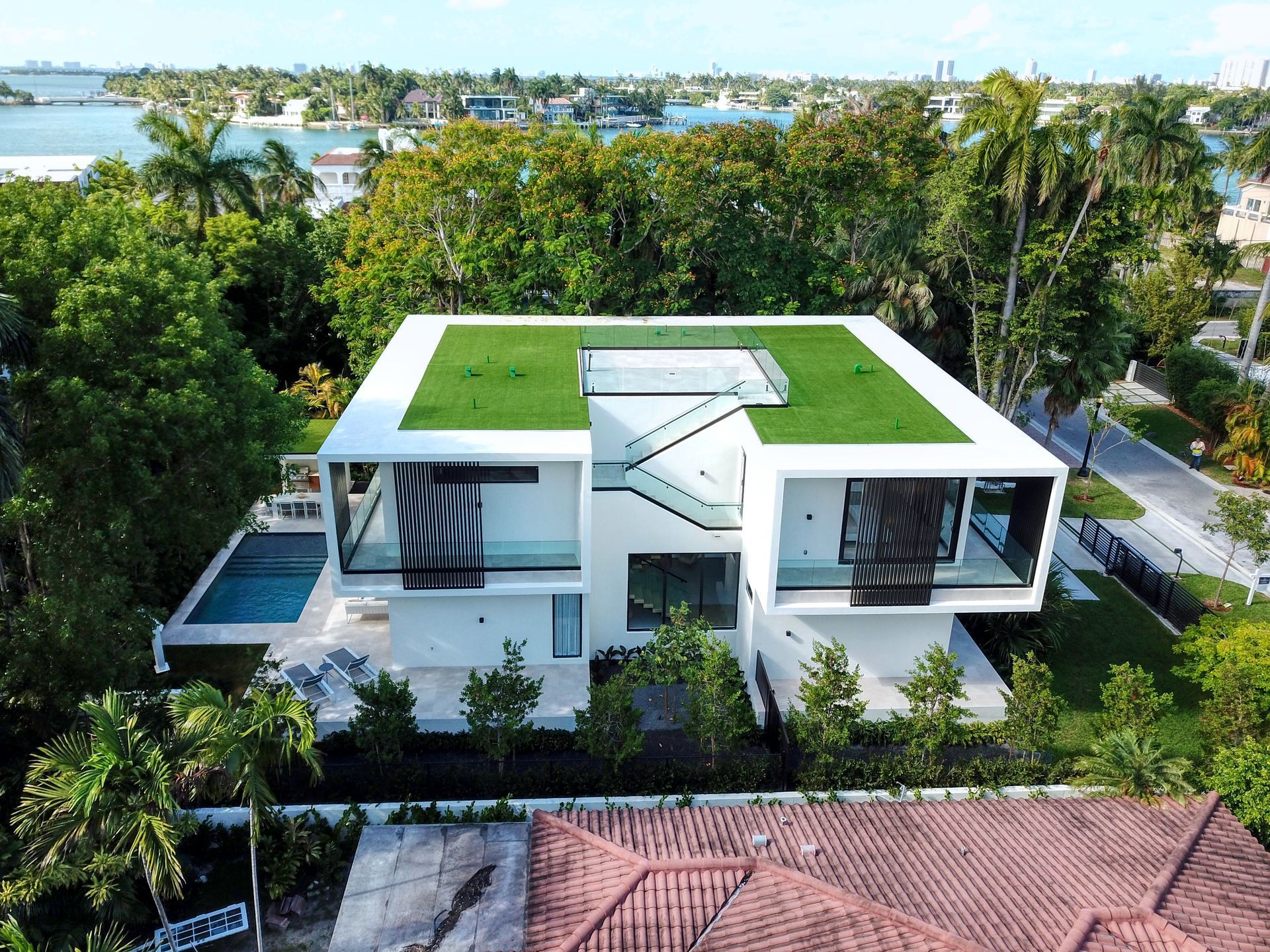 An aerial view of a modern house with a green roof