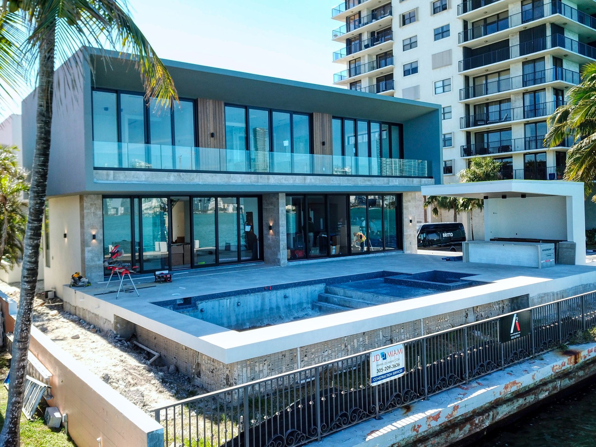 A large house with a swimming pool in front of it.