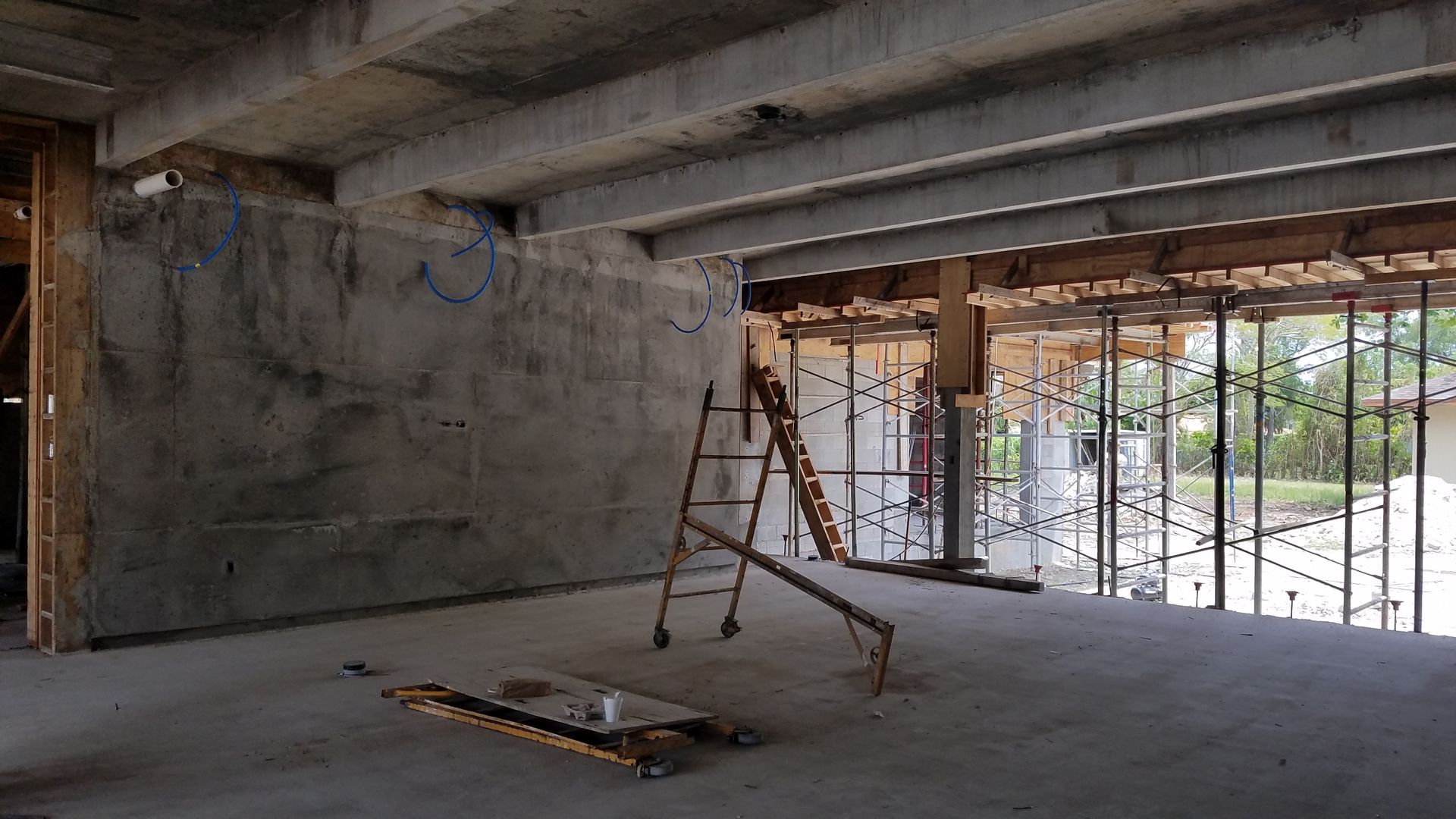An empty room with a ladder in the middle of it