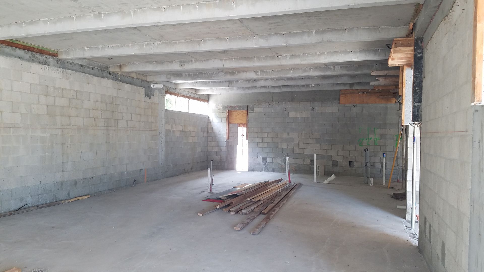 A large empty room with brick walls and a ceiling.