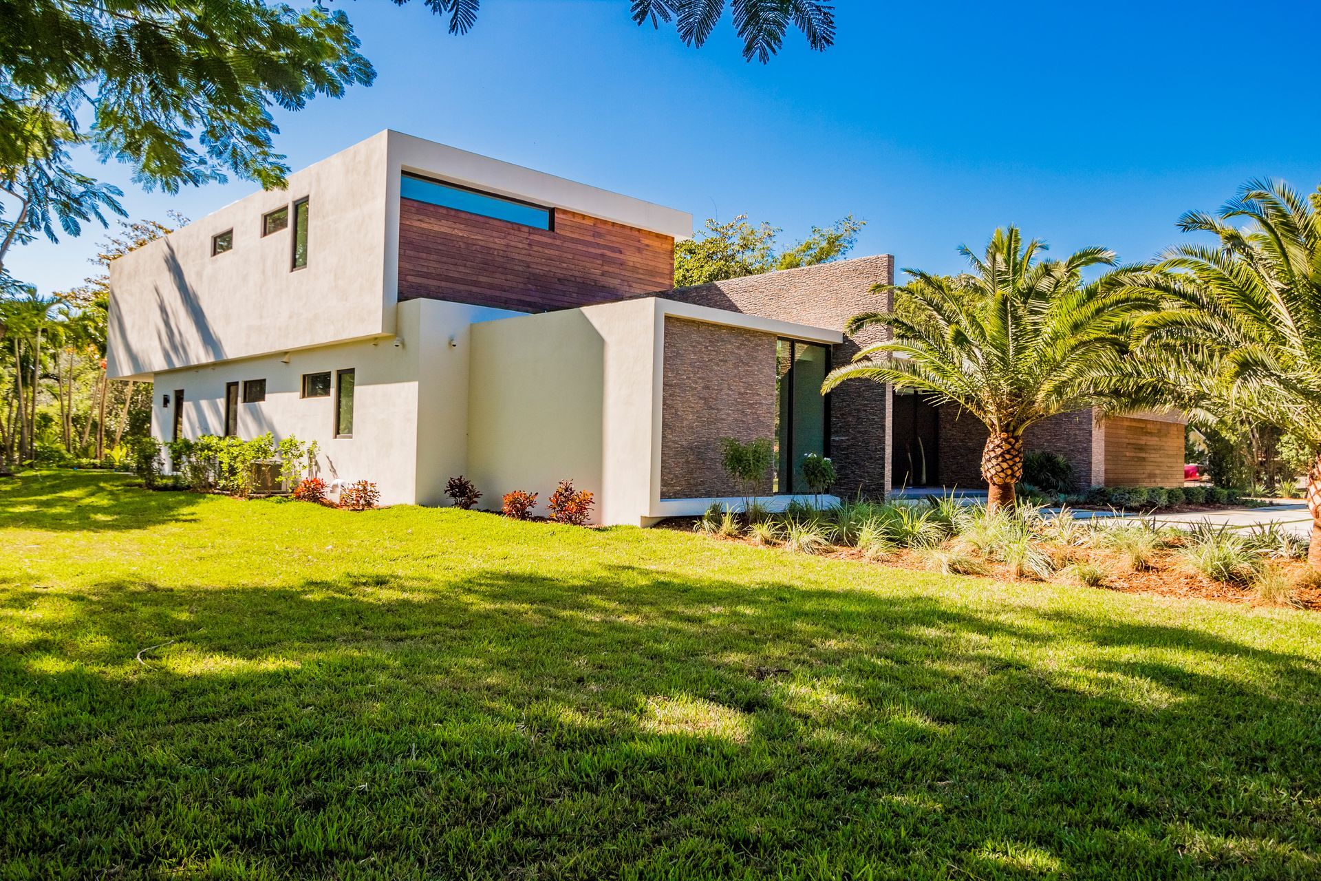 A large white house with a lot of grass in front of it.