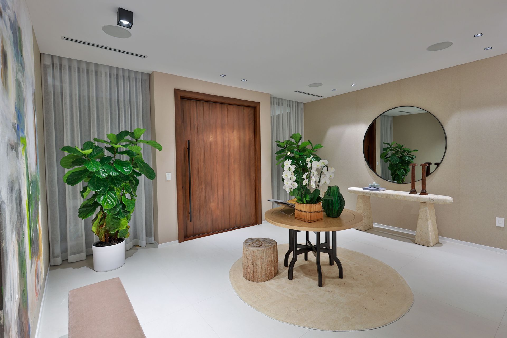 A living room with a table and a mirror