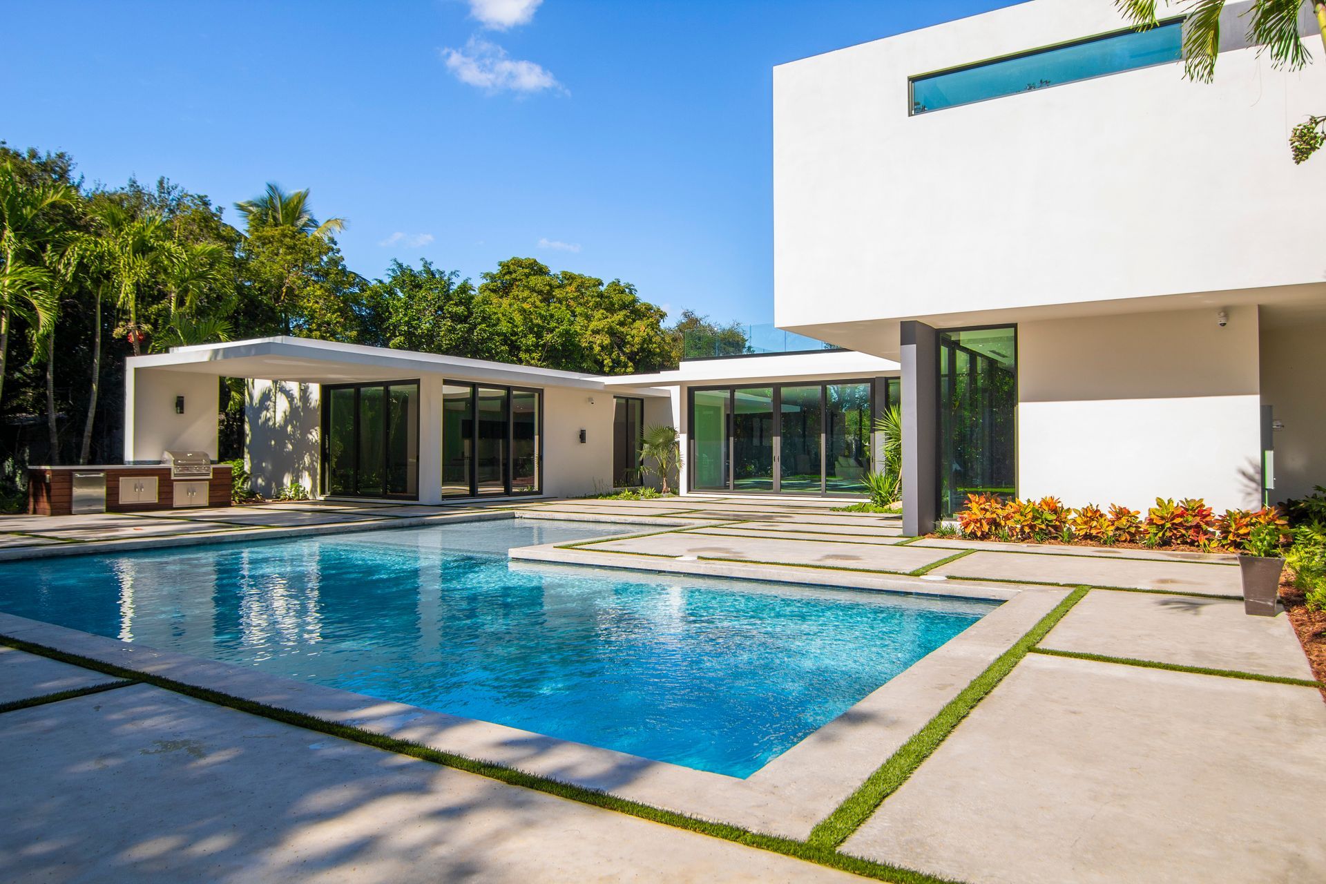 A large white house with a large swimming pool in front of it