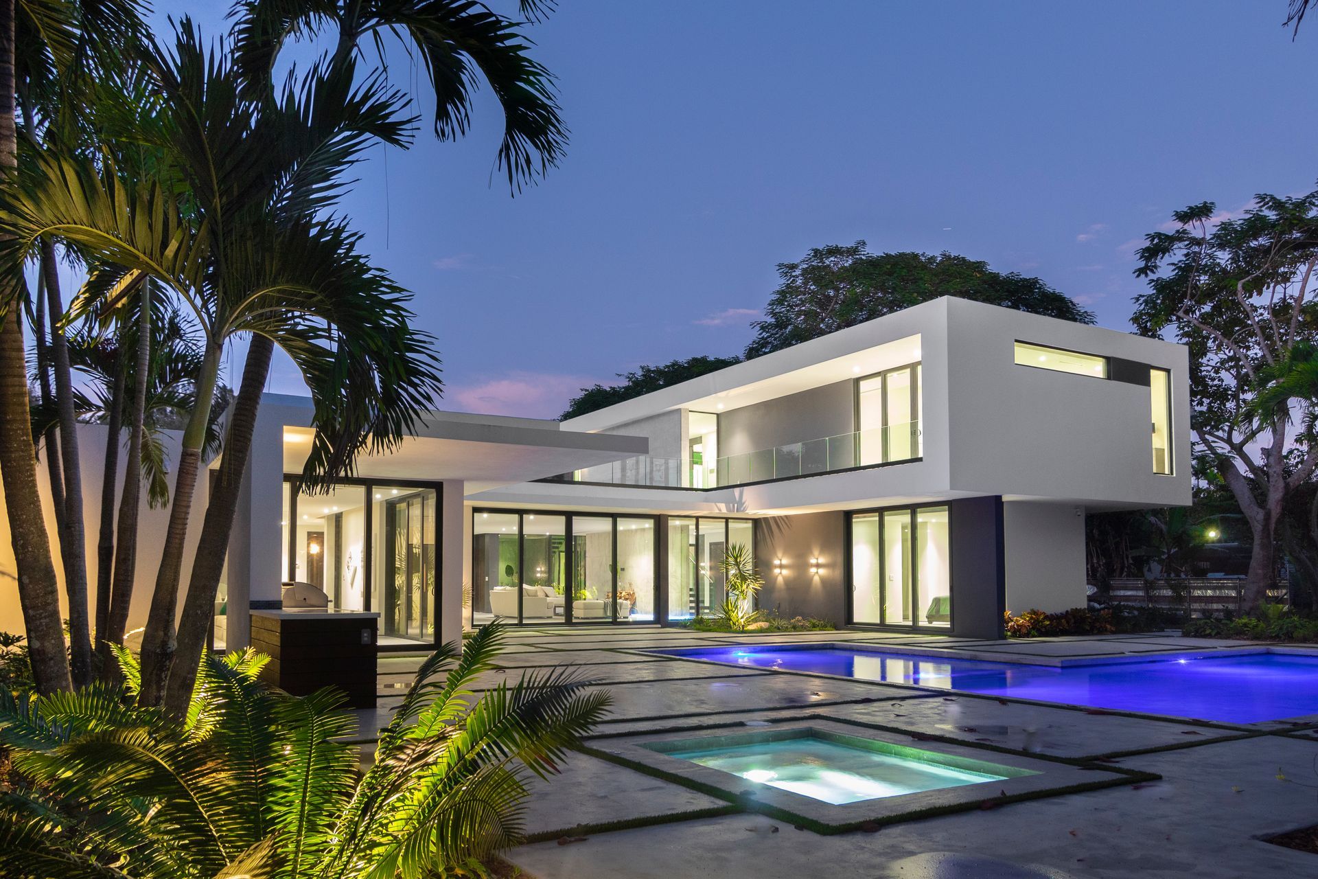 A large white house with a swimming pool in front of it