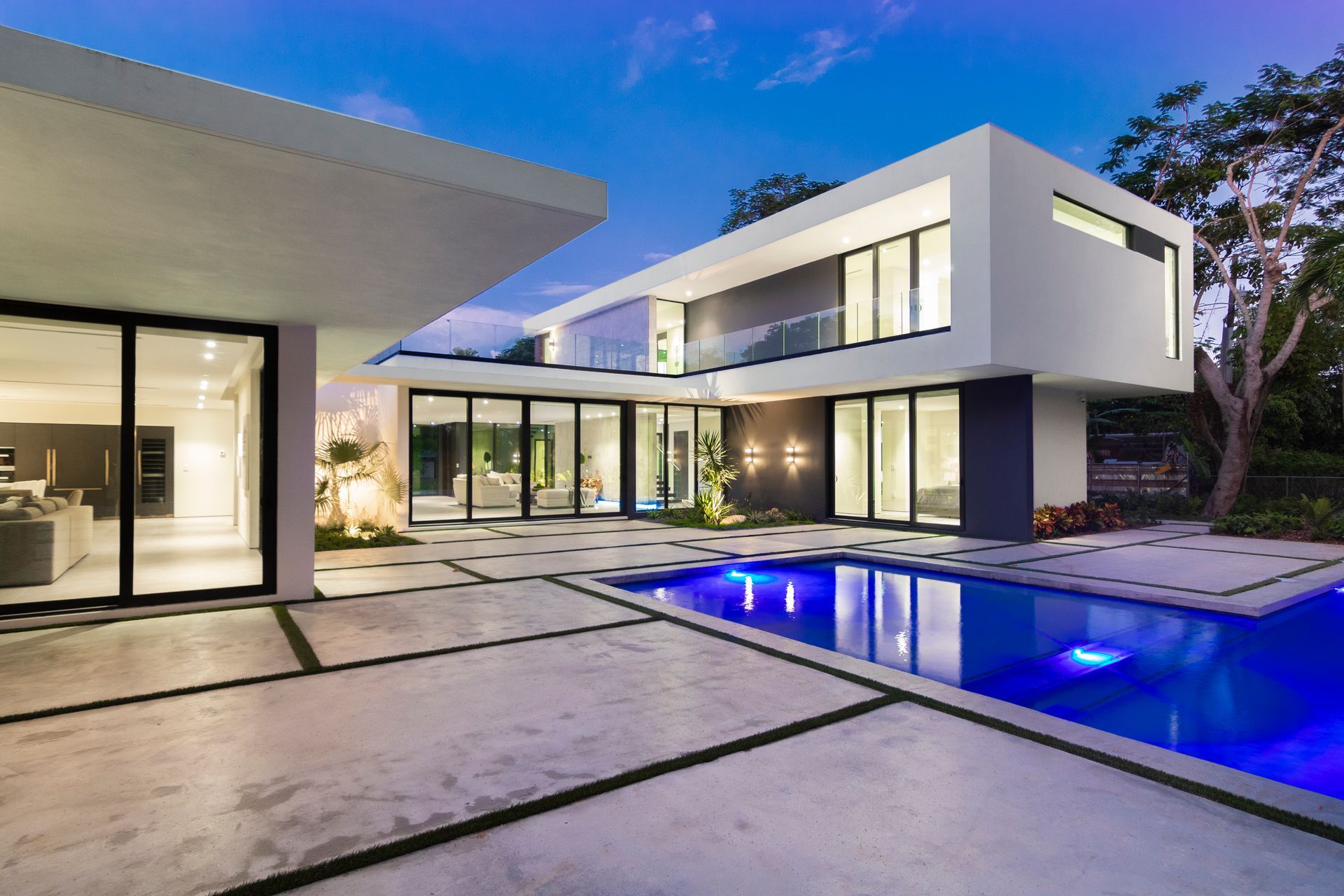 A modern house with a large swimming pool in front of it