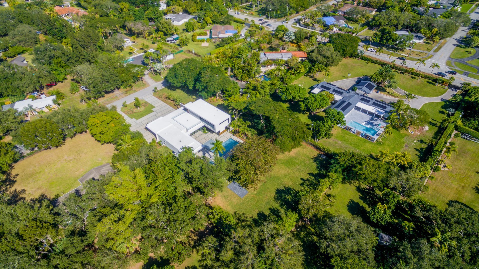 An aerial view of a residential area with lots of trees and houses.