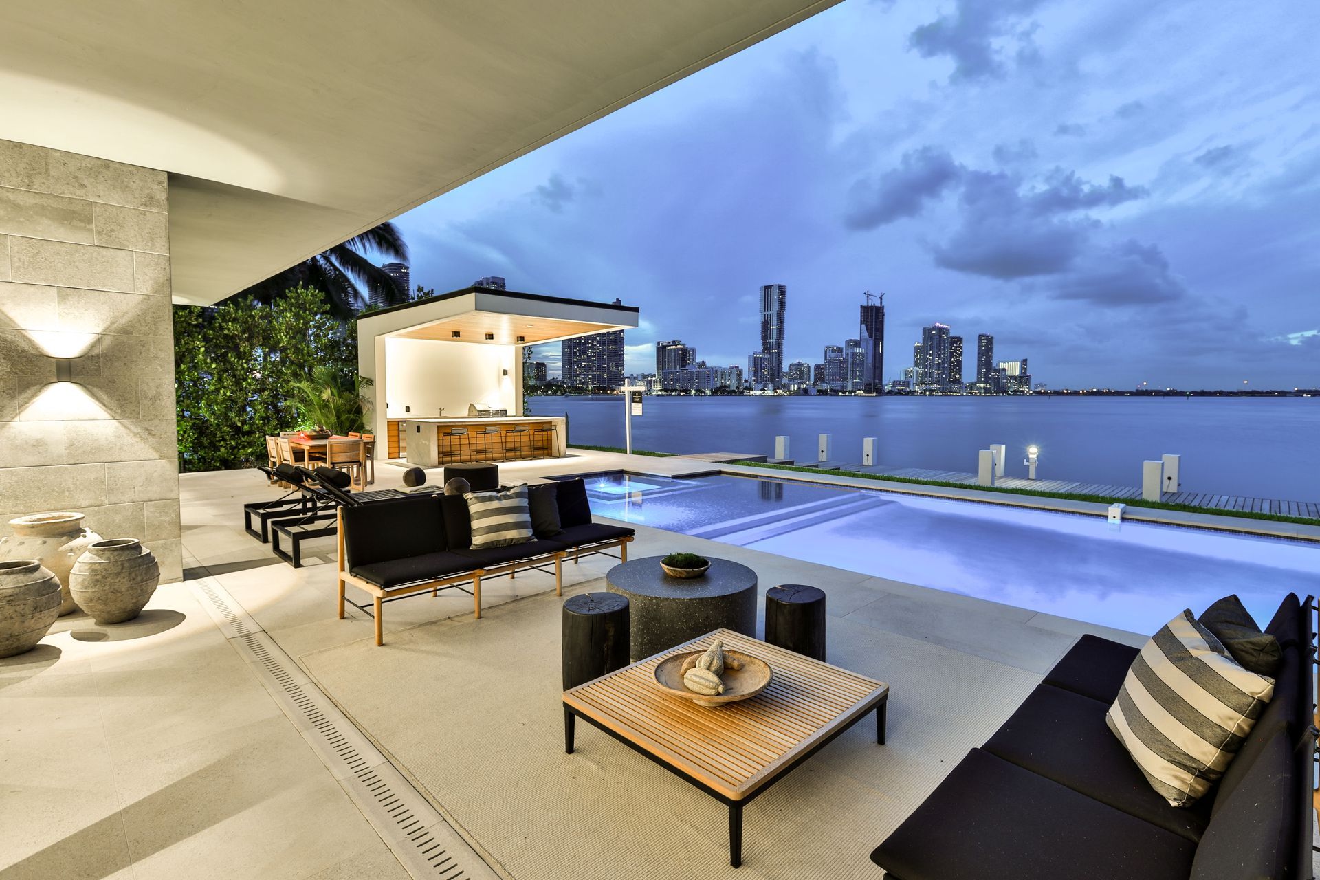 A patio with a swimming pool and a view of the city