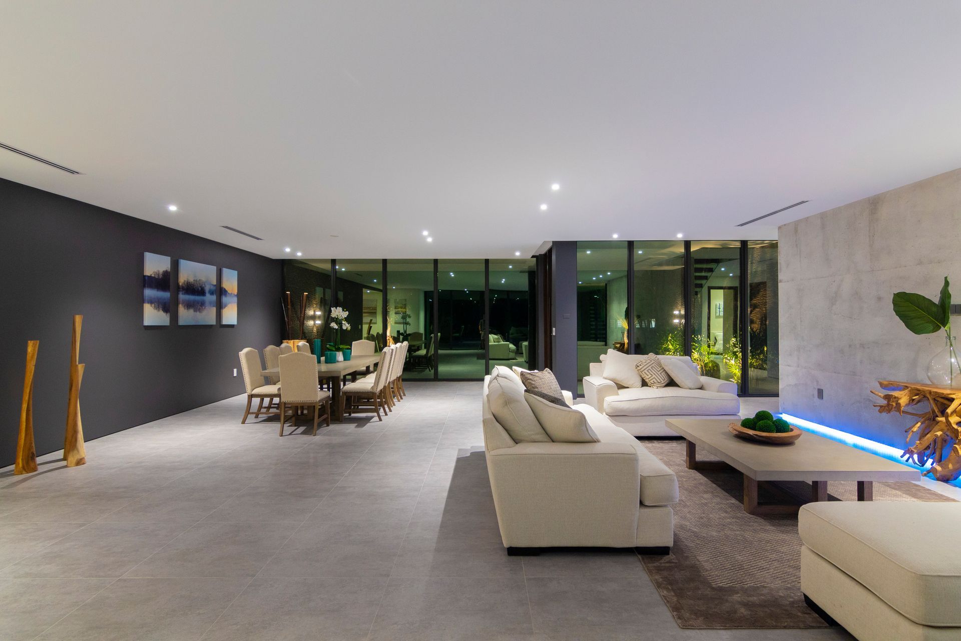 A living room with a couch , table and chairs