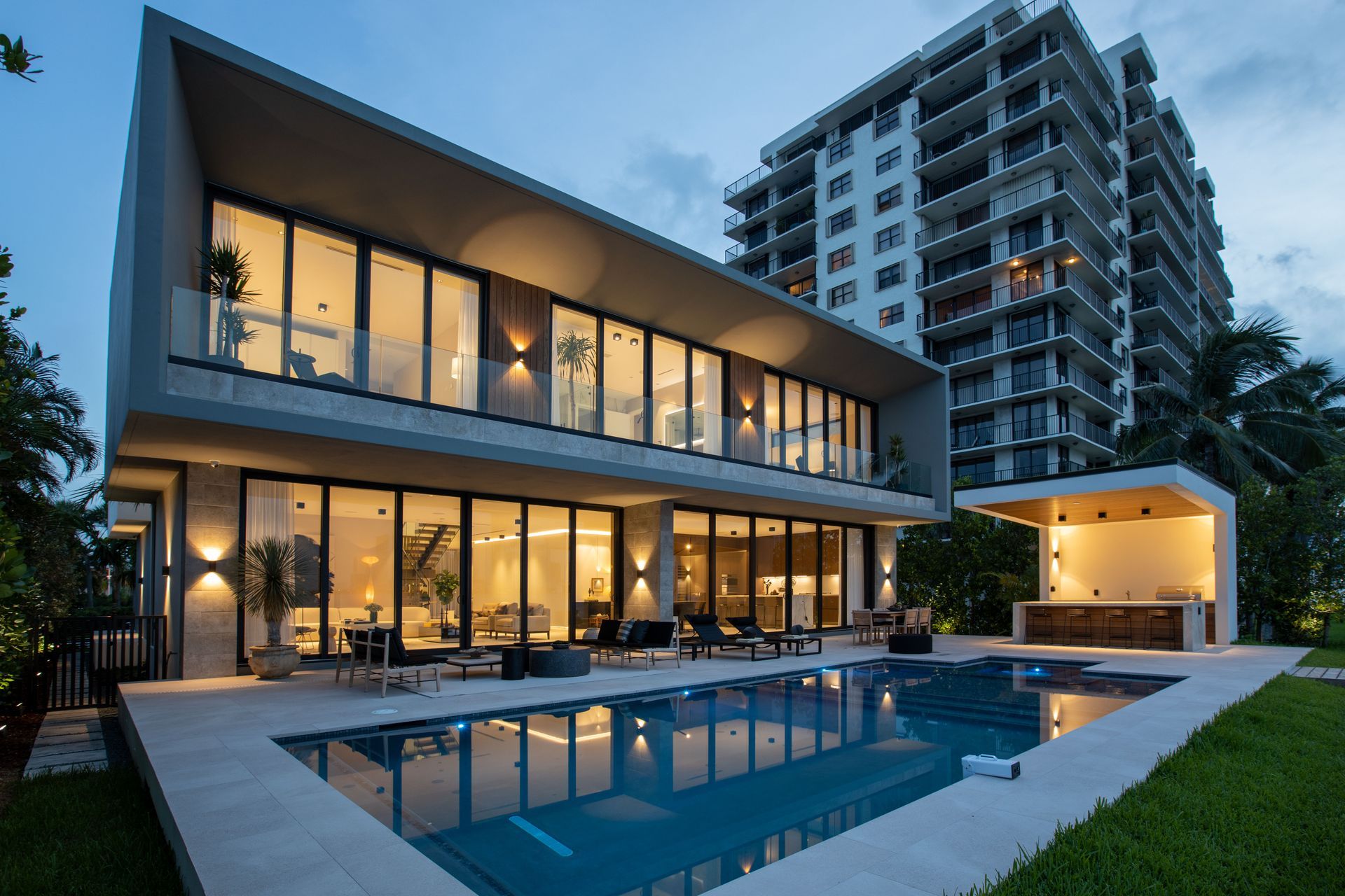 A large house with a swimming pool in front of it