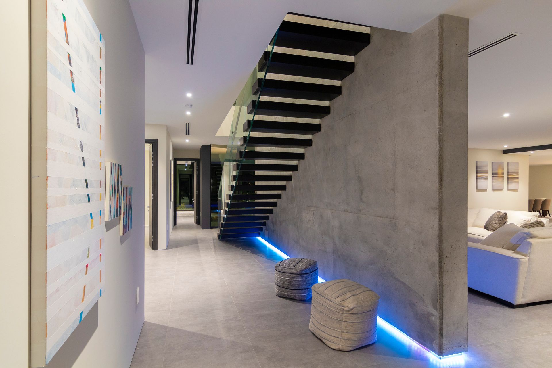 A hallway with a staircase leading up to the second floor