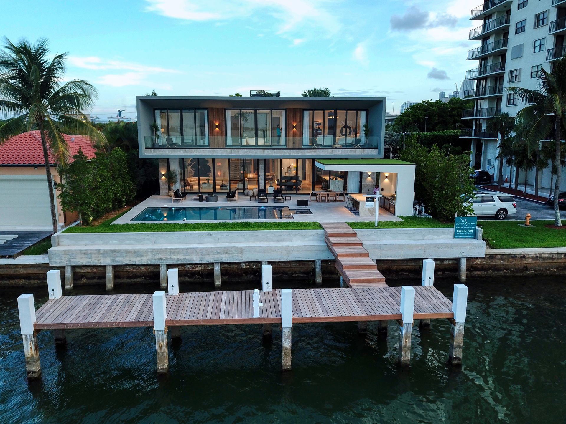 An aerial view of a house with a dock in front of it