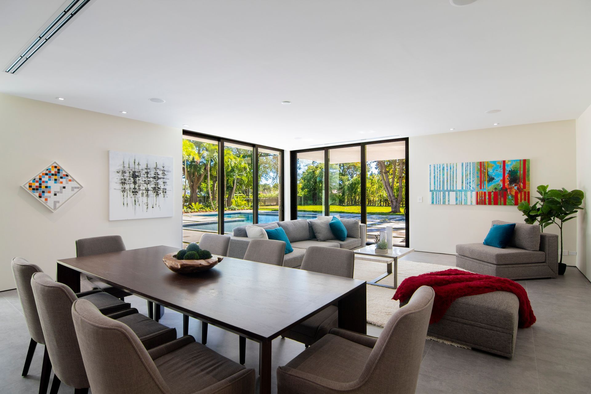 A living room with a dining table and chairs