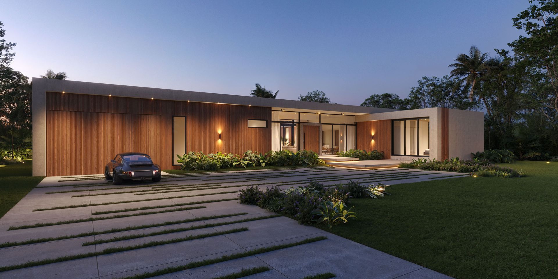 Modern house with a car parked in front, illuminated at dusk. Lush greenery and a long driveway.