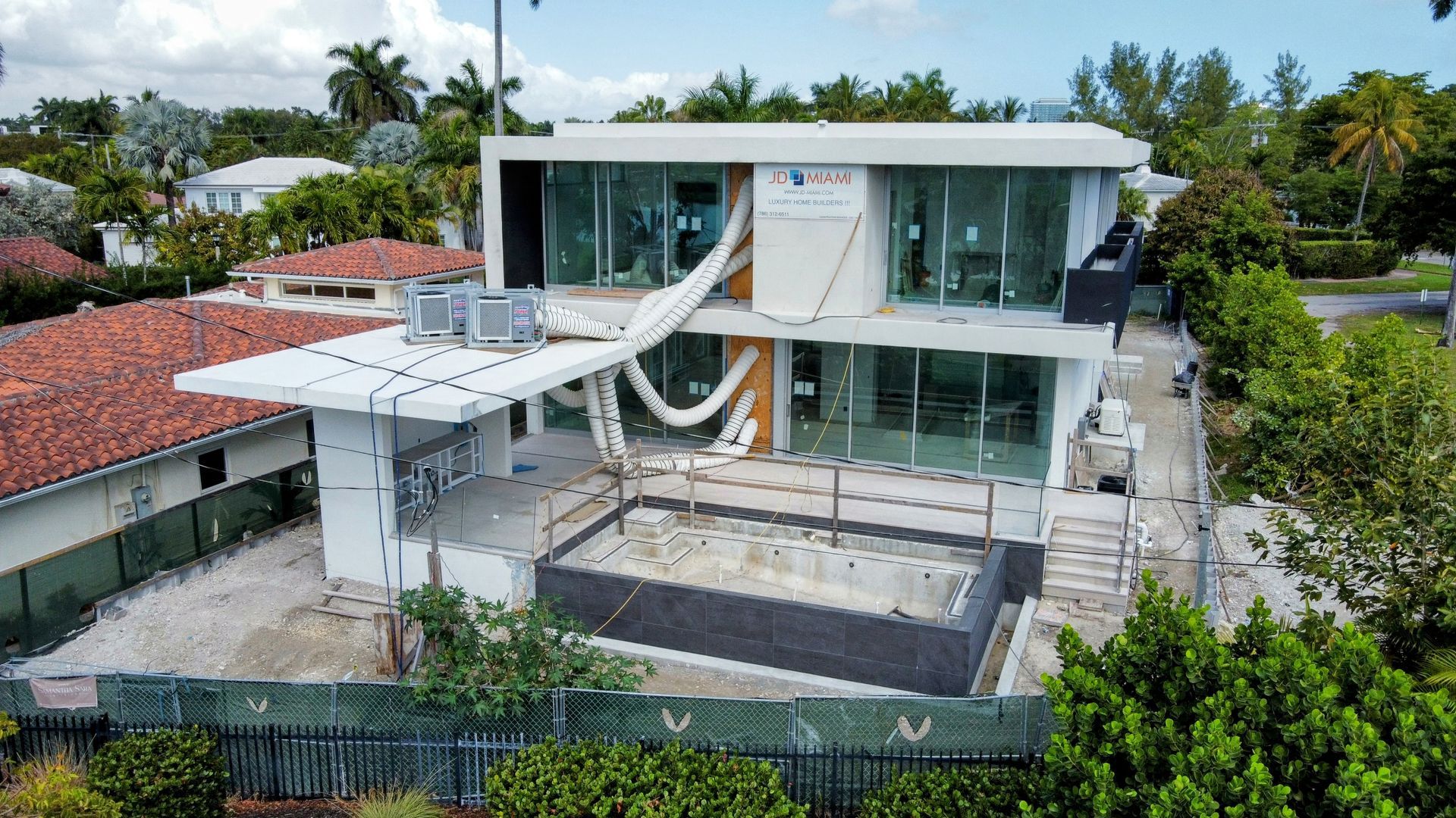 An aerial view of a house under construction with a hammock in the backyard.