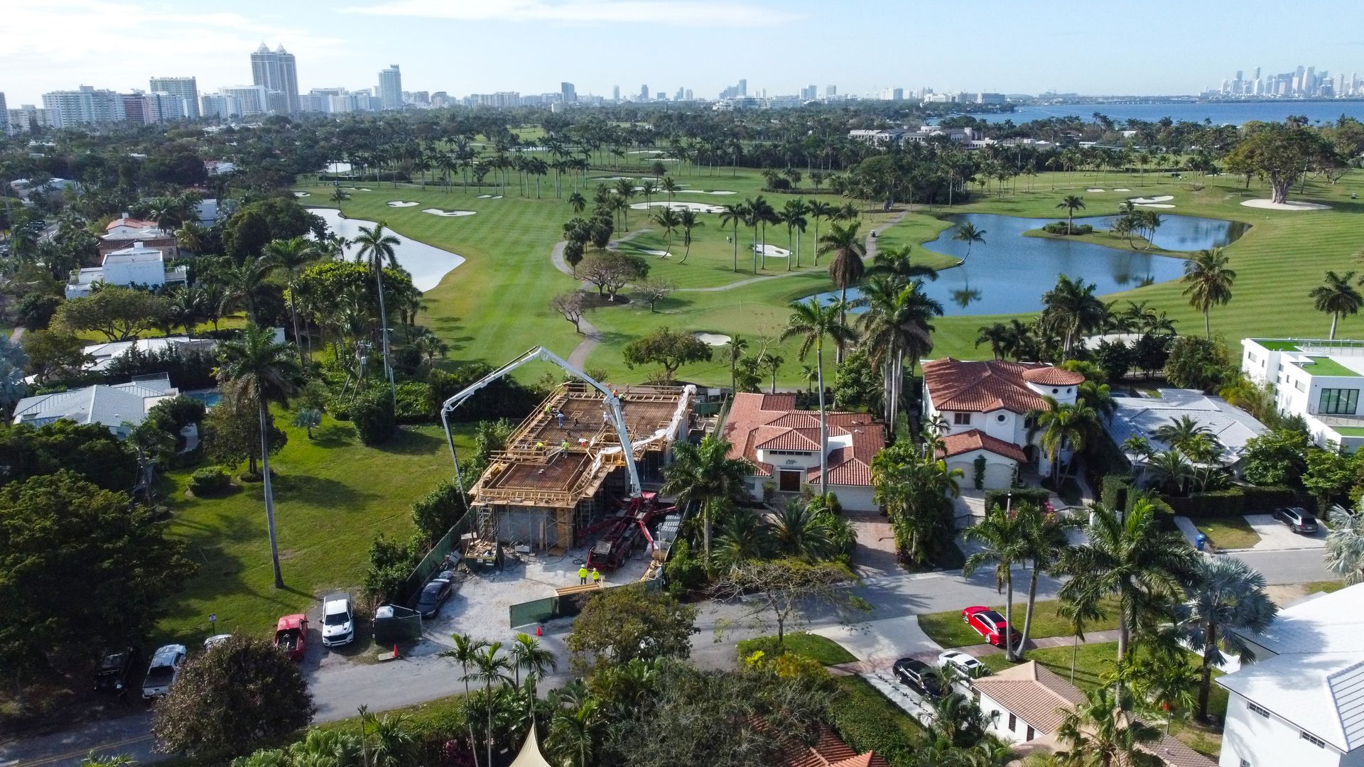 An aerial view of a residential area with a golf course in the background.
