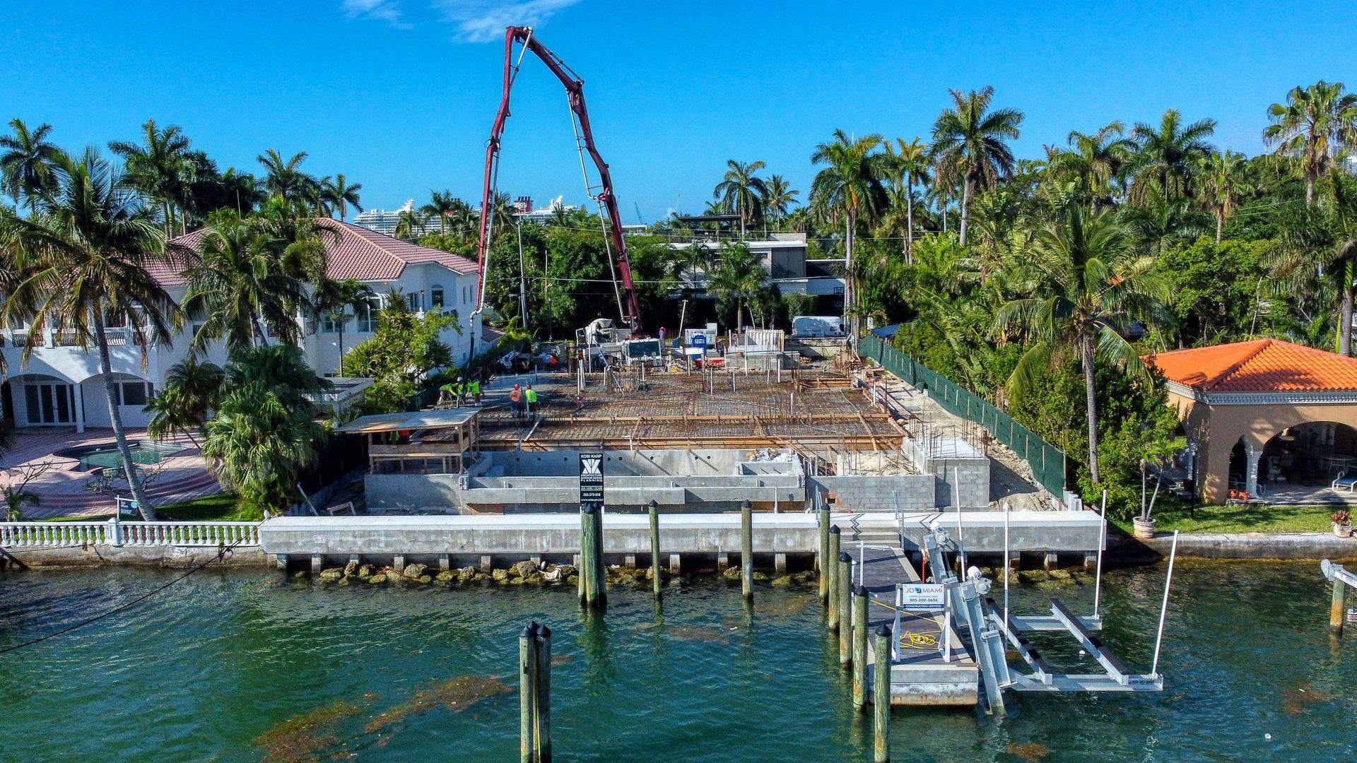 An aerial view of a construction site next to a body of water.