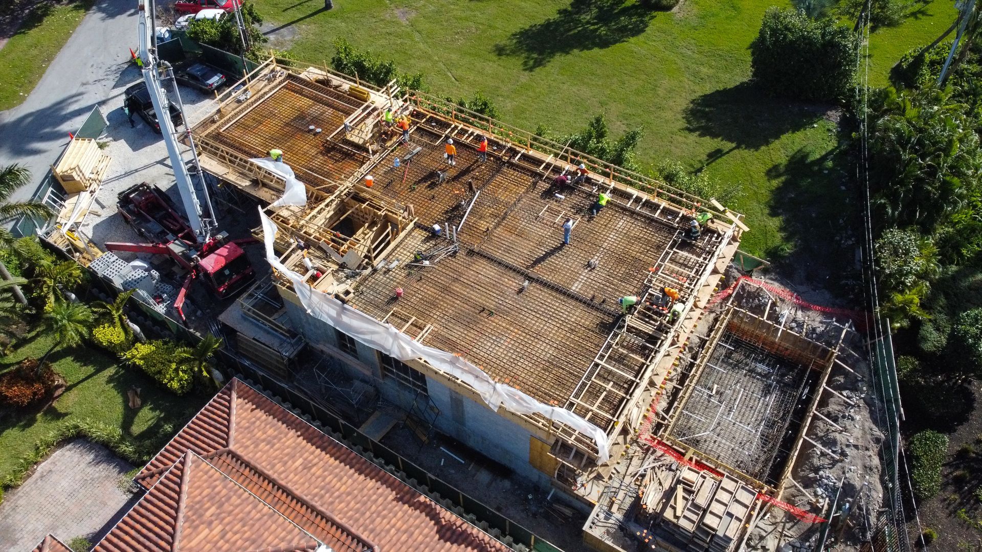 An aerial view of a building under construction with a crane.