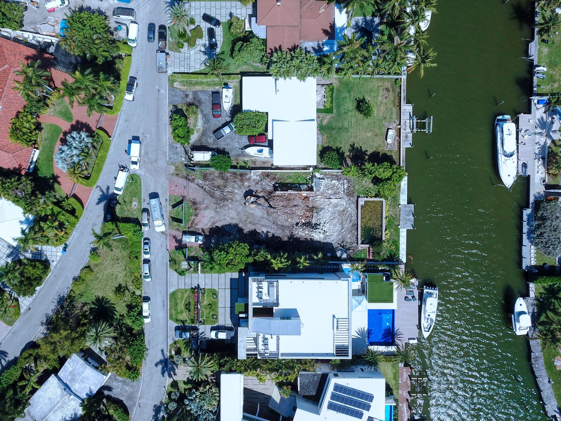 An aerial view of a residential area with a boat in the water.