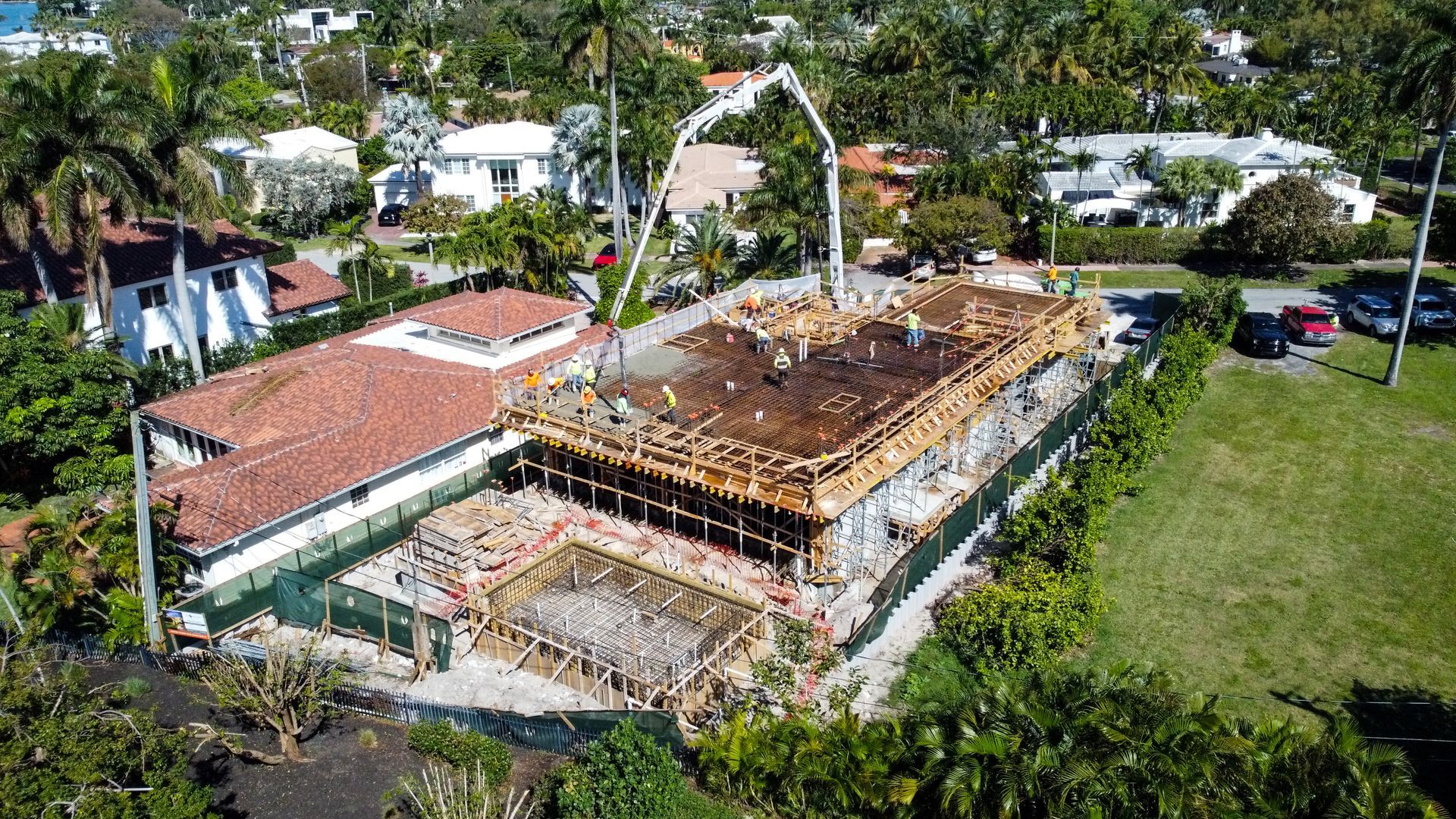 An aerial view of a building under construction in a residential area.