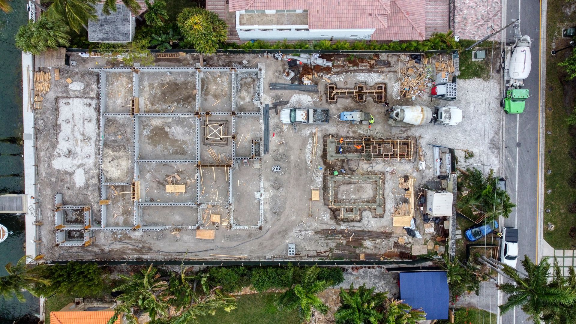 An aerial view of a building under construction in a residential area.