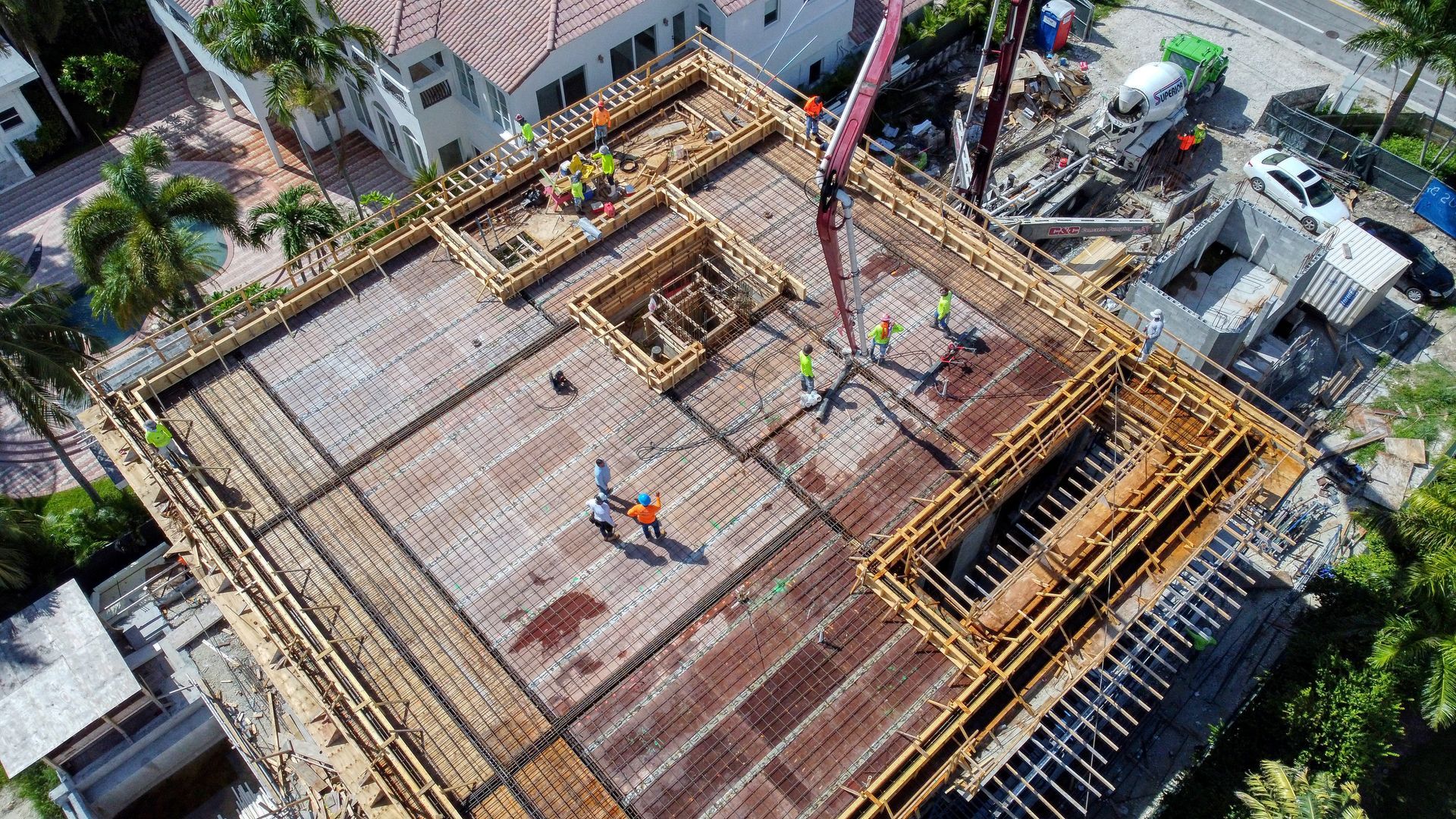 An aerial view of a building under construction in a city.