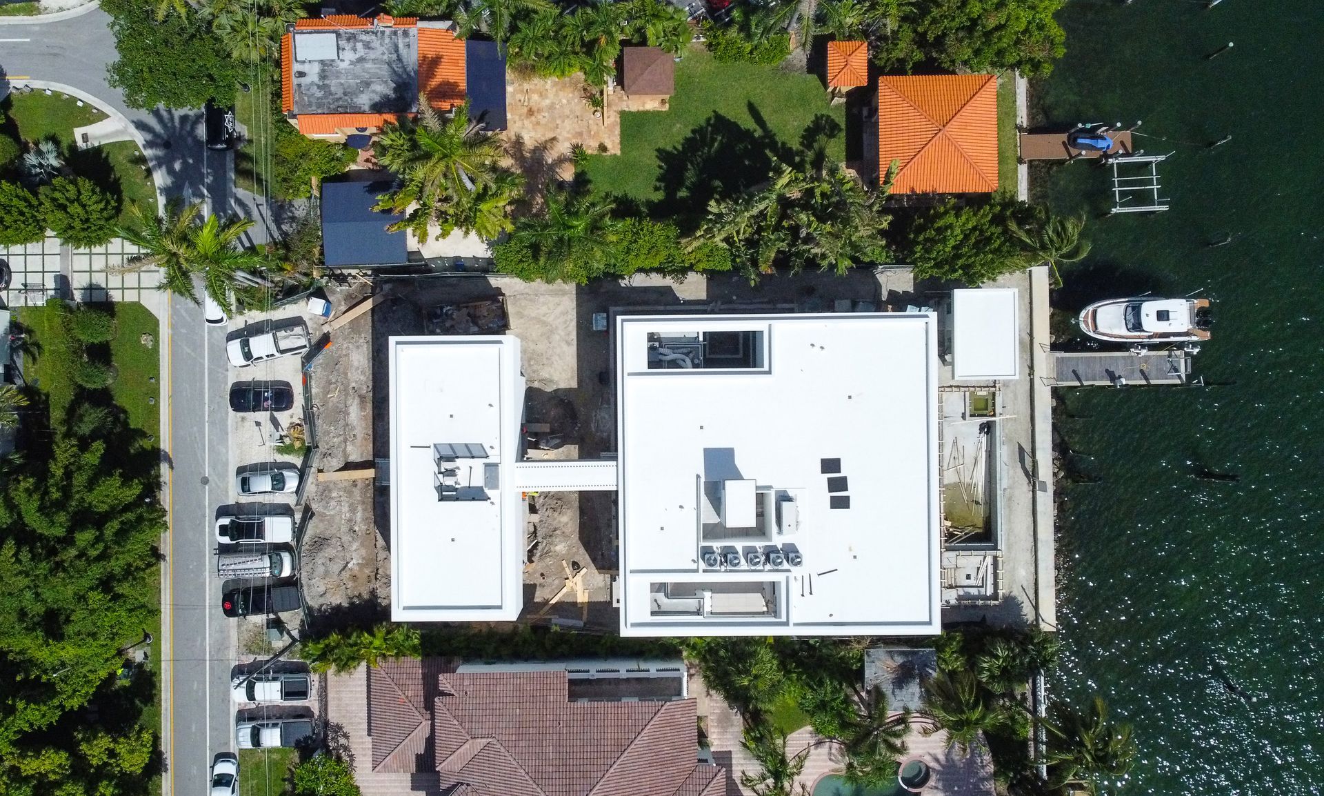 An aerial view of a house next to a body of water