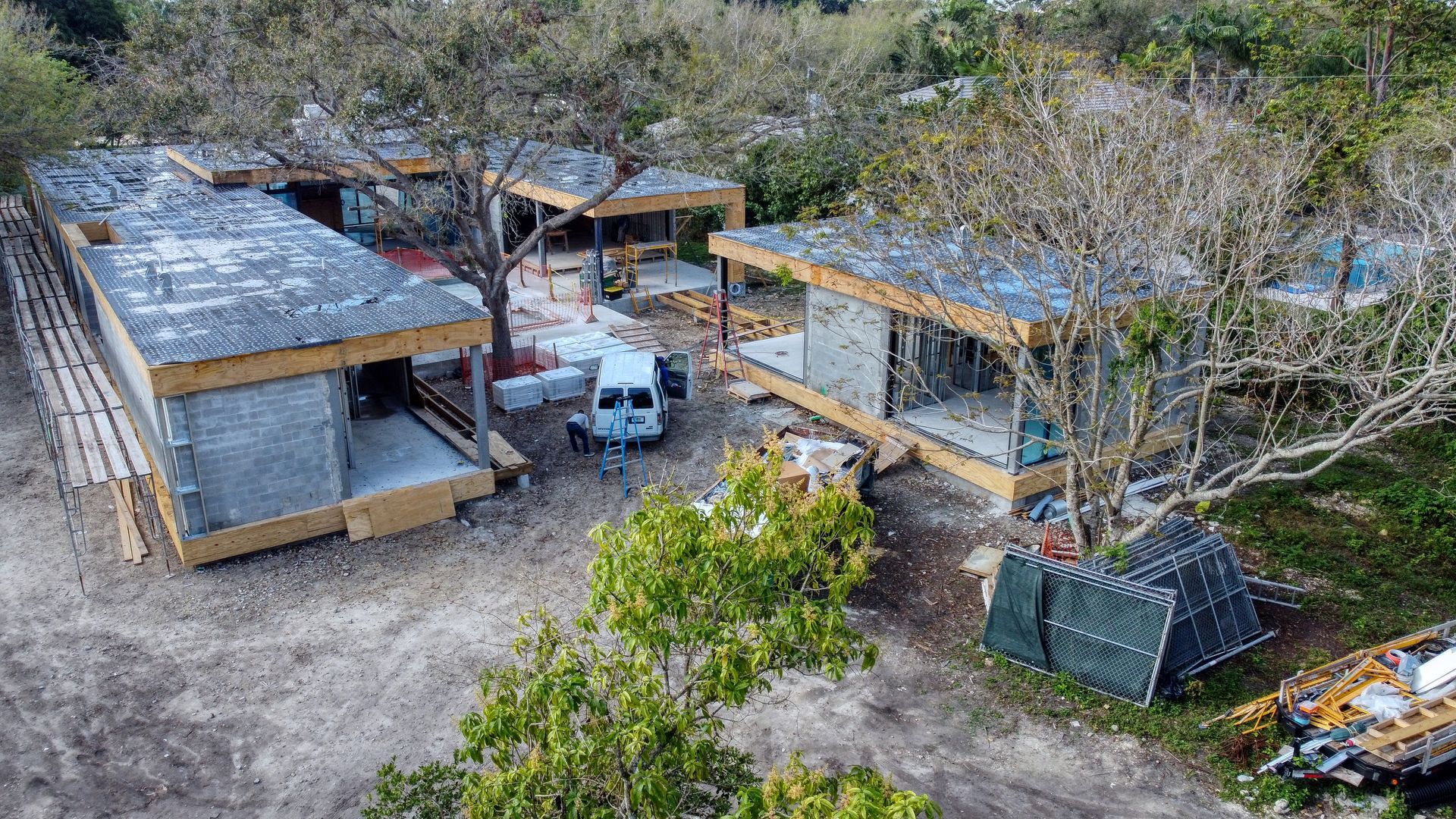 Construction site with multiple modular buildings in varying stages of completion.