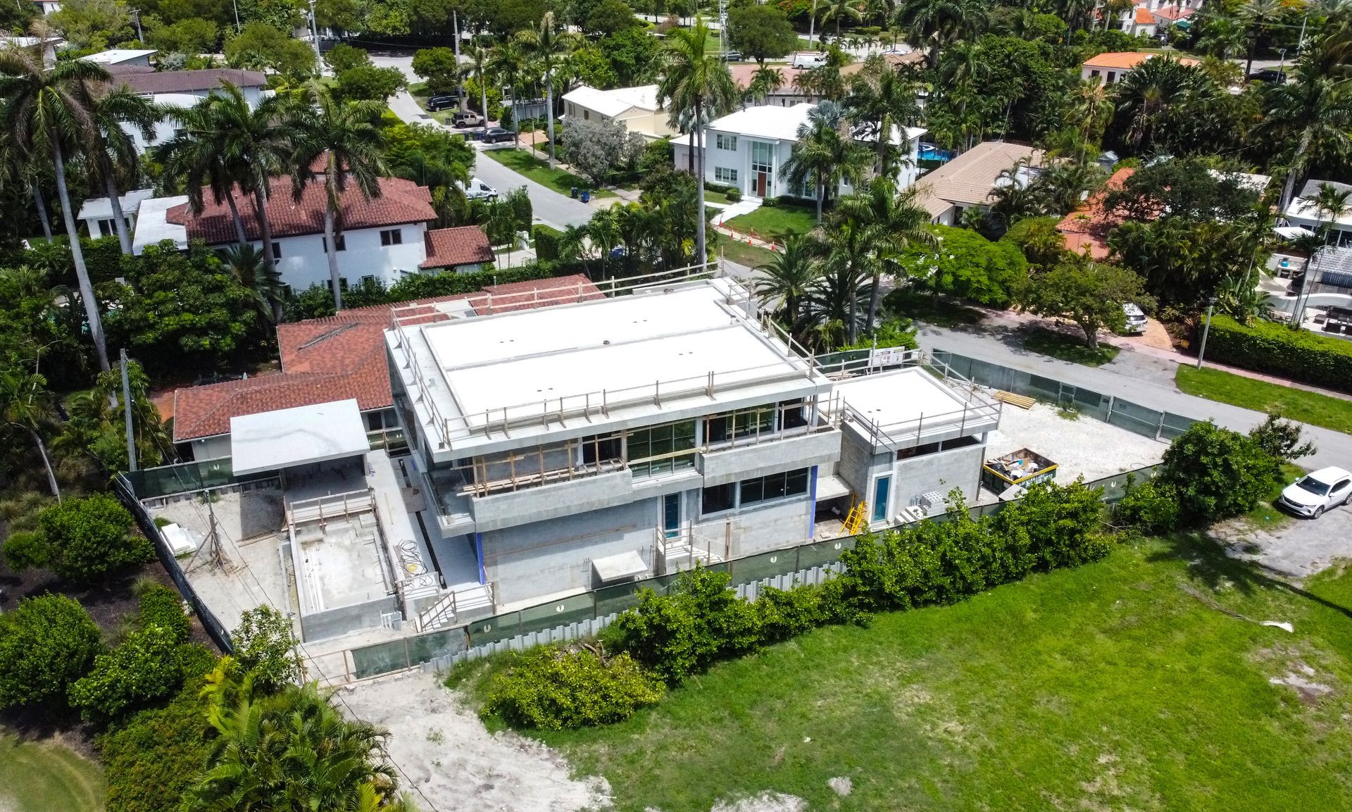 An aerial view of a house under construction in a residential area.