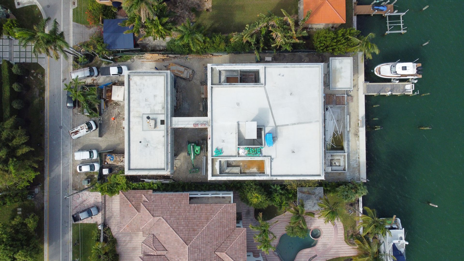 An aerial view of a house next to a body of water