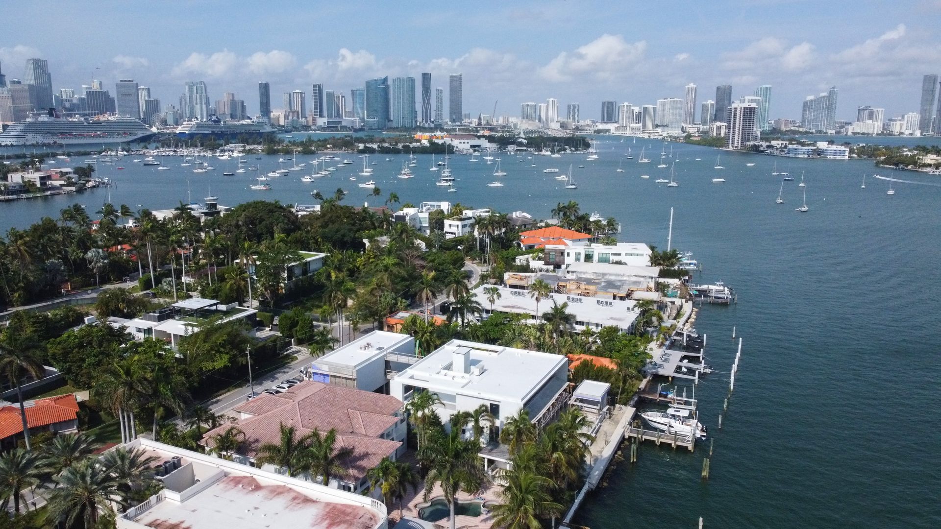 An aerial view of a city with a lot of boats in the water