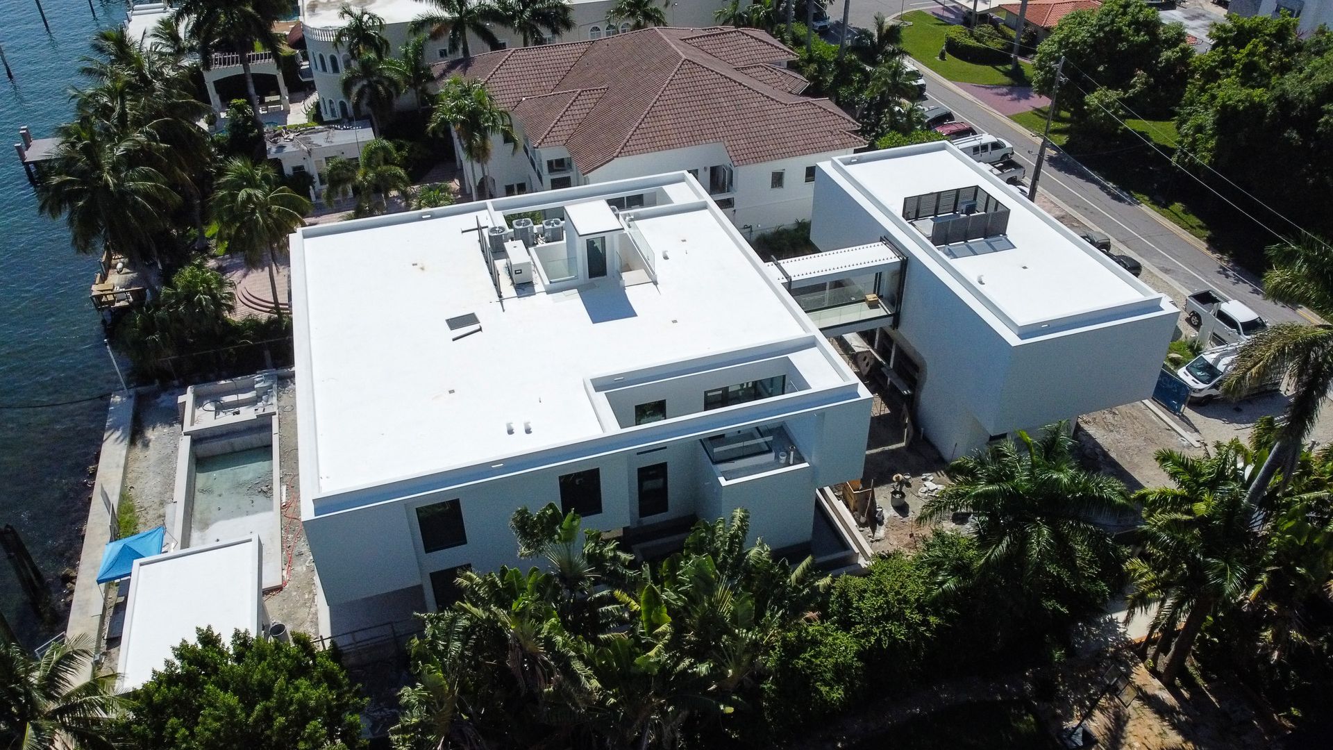 An aerial view of a house with a white roof