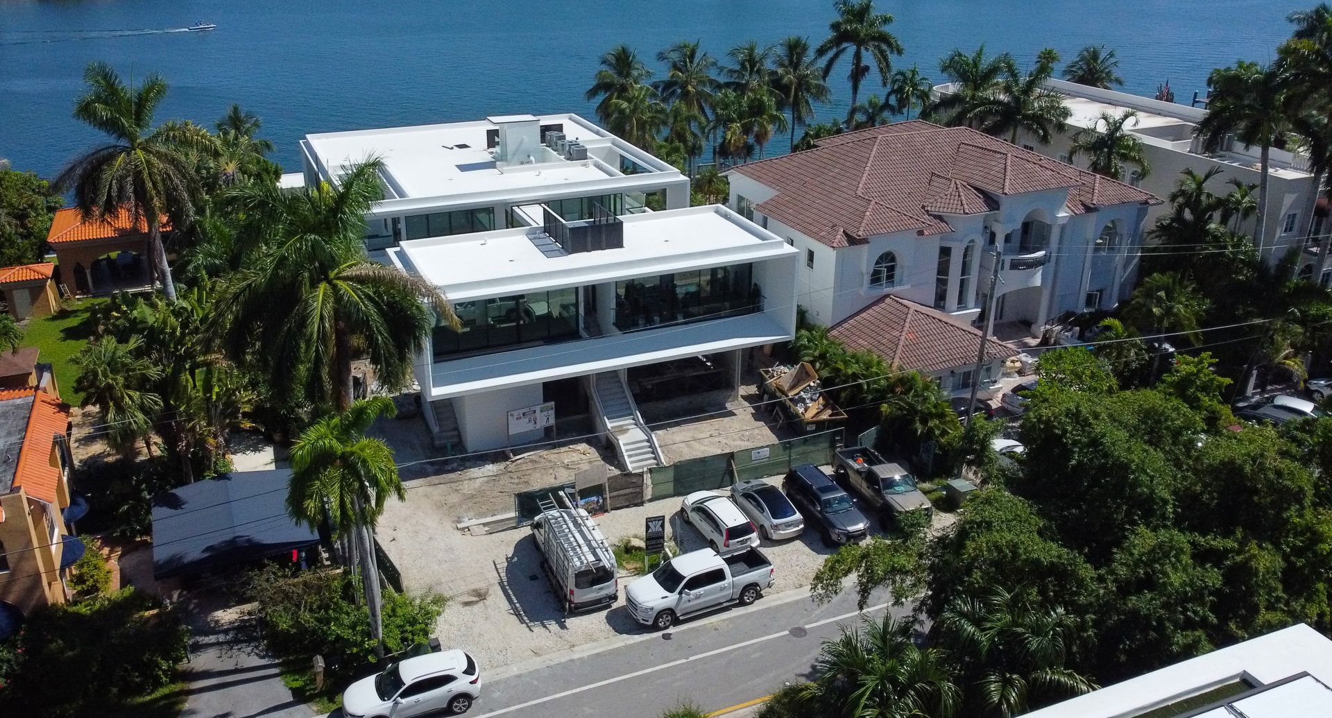 An aerial view of a building with a lot of cars parked in front of it