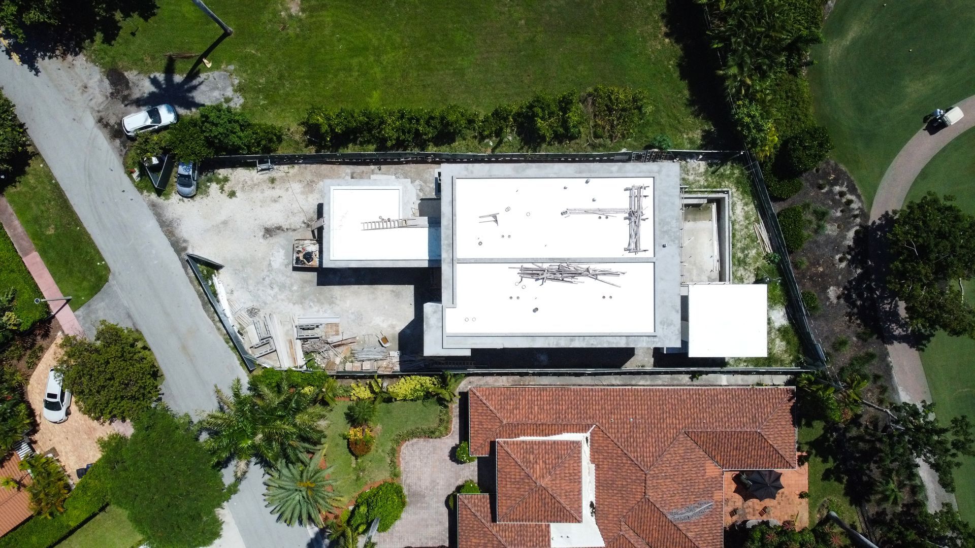 An aerial view of a house with a white roof