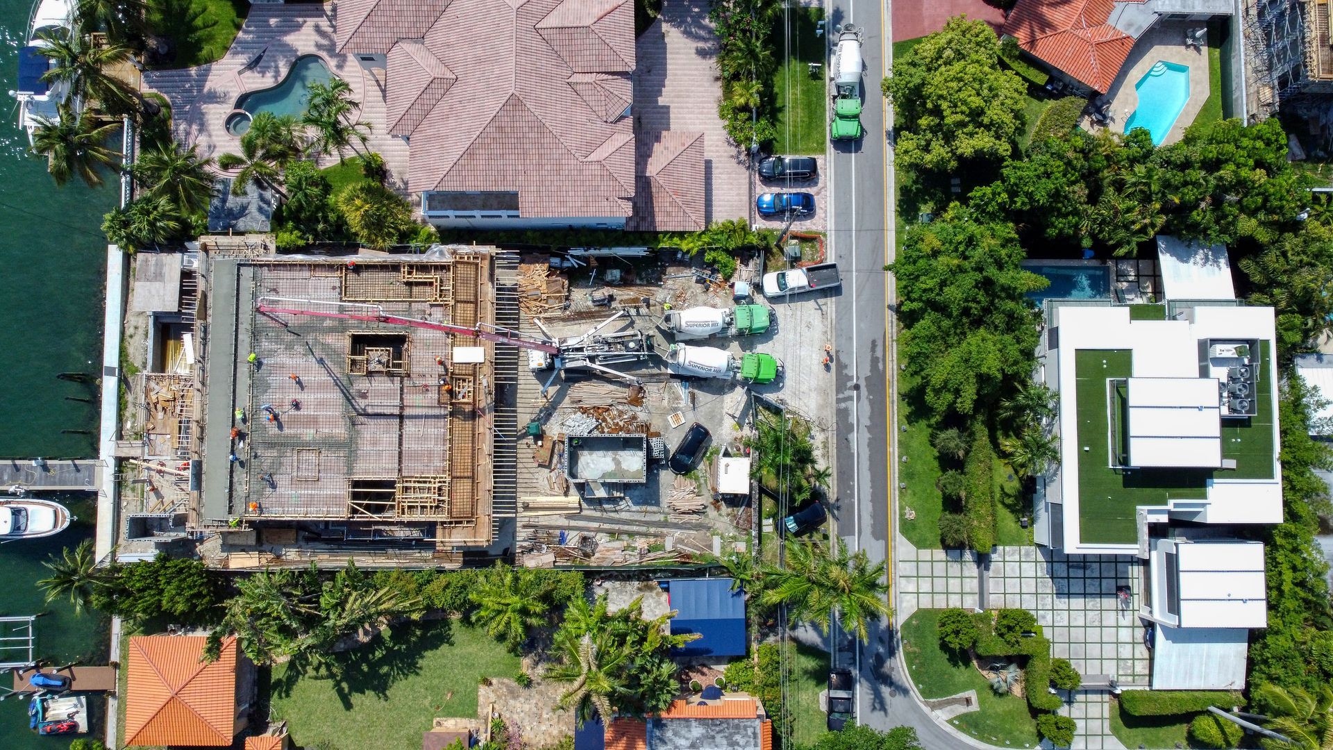 An aerial view of a house under construction in a residential area.