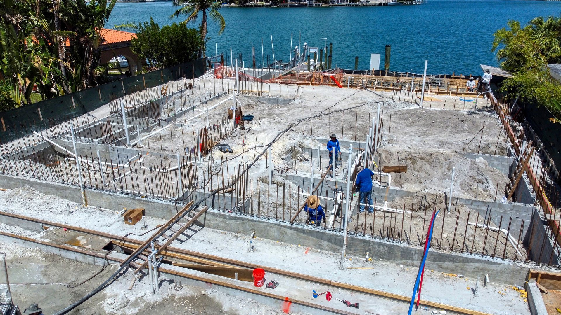 An aerial view of a construction site next to a body of water.