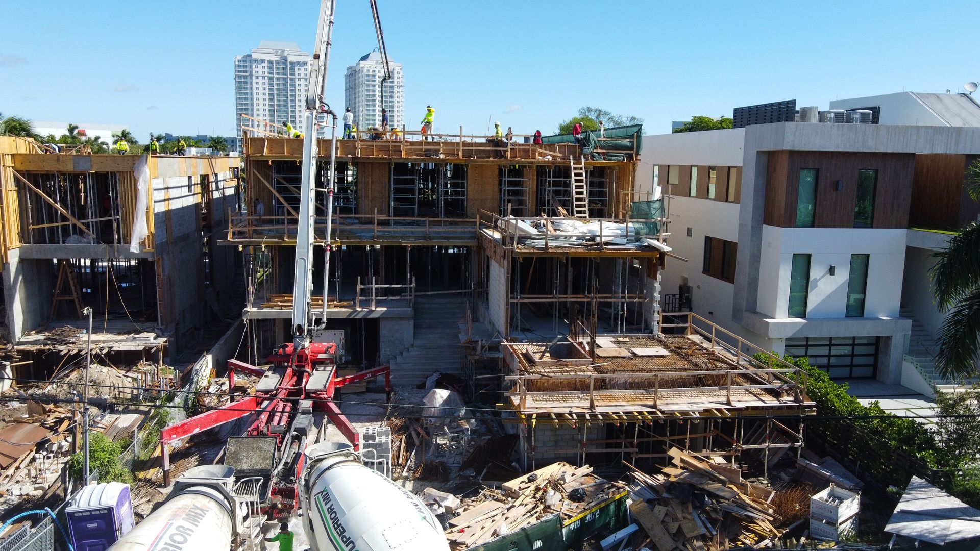 Construction site with concrete pump pouring concrete for a multi-story building.