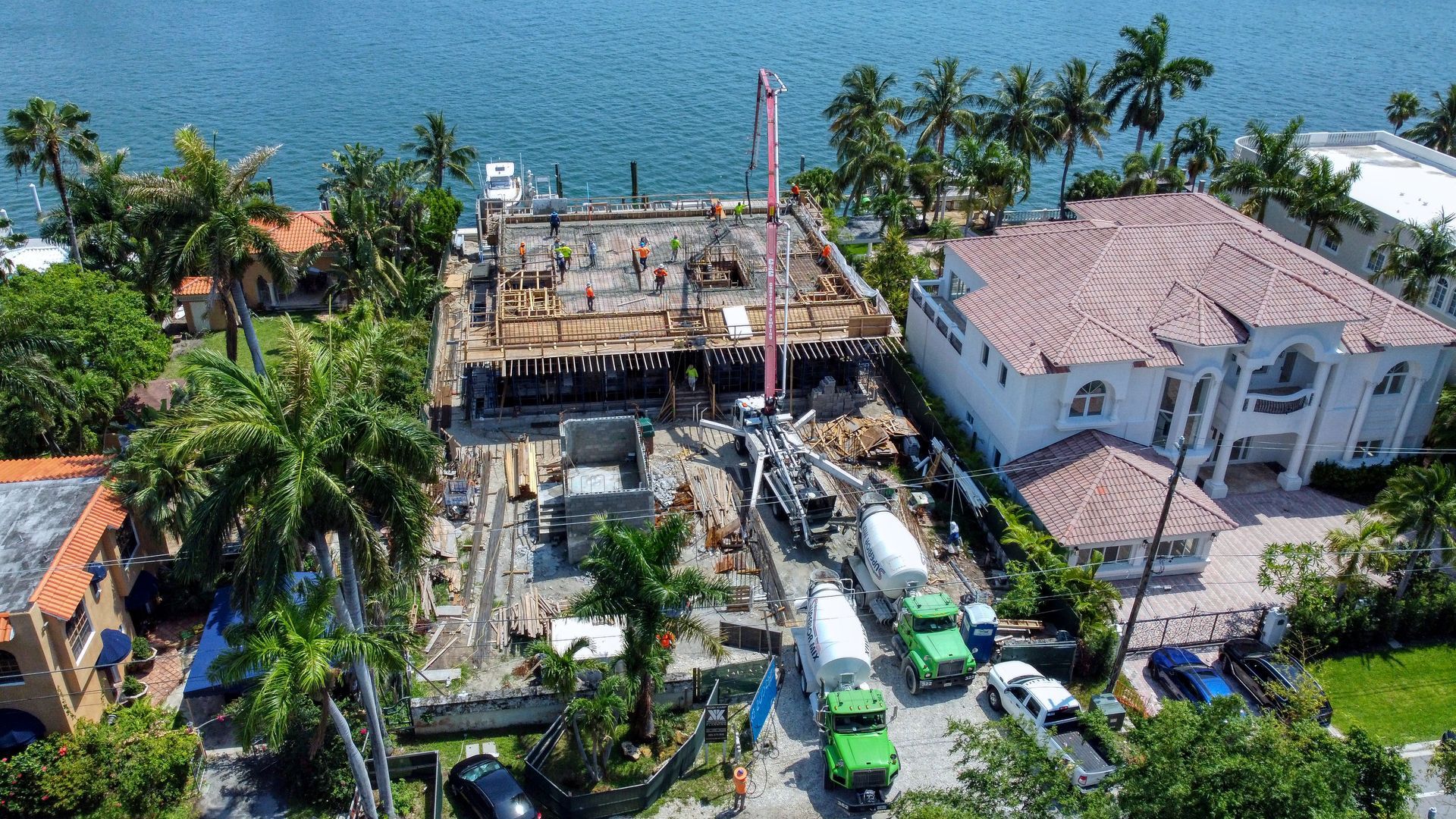 An aerial view of a building under construction next to a body of water.