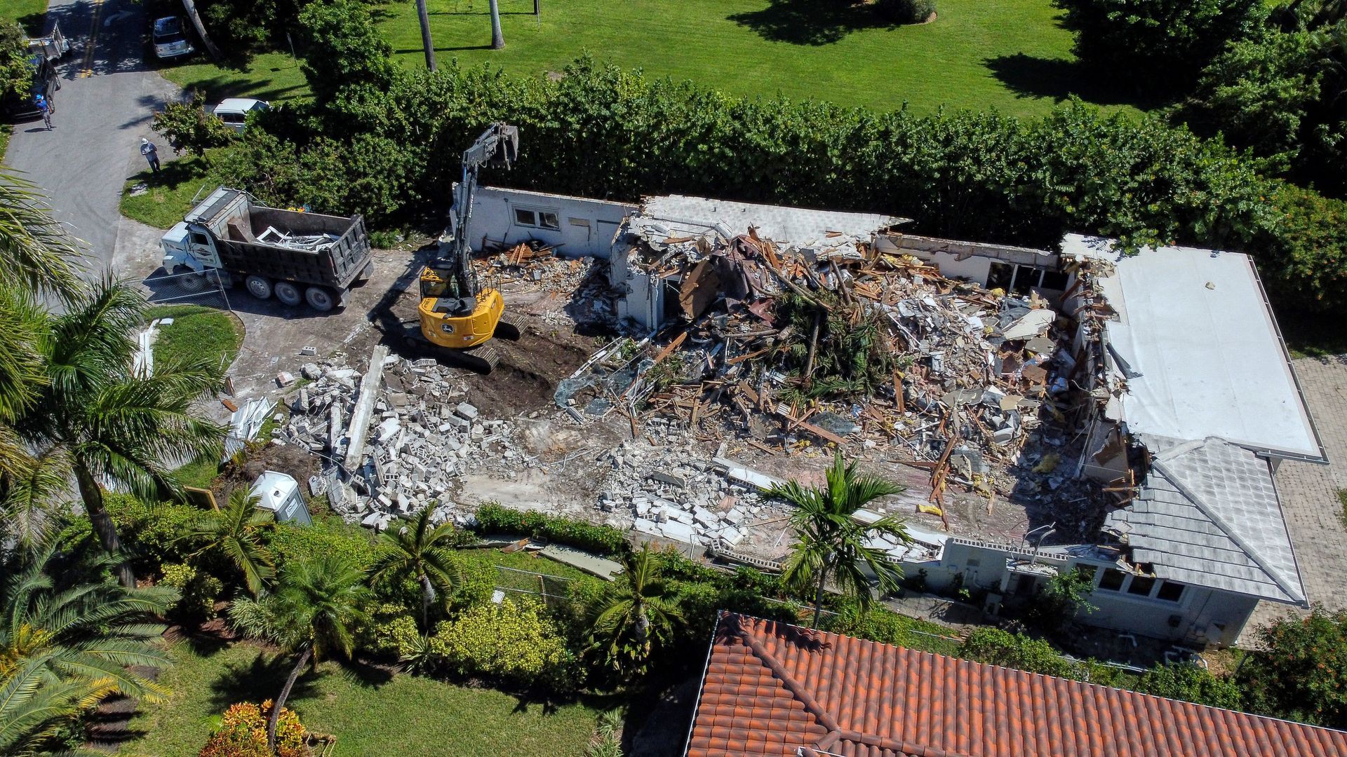 An aerial view of a house being demolished.
