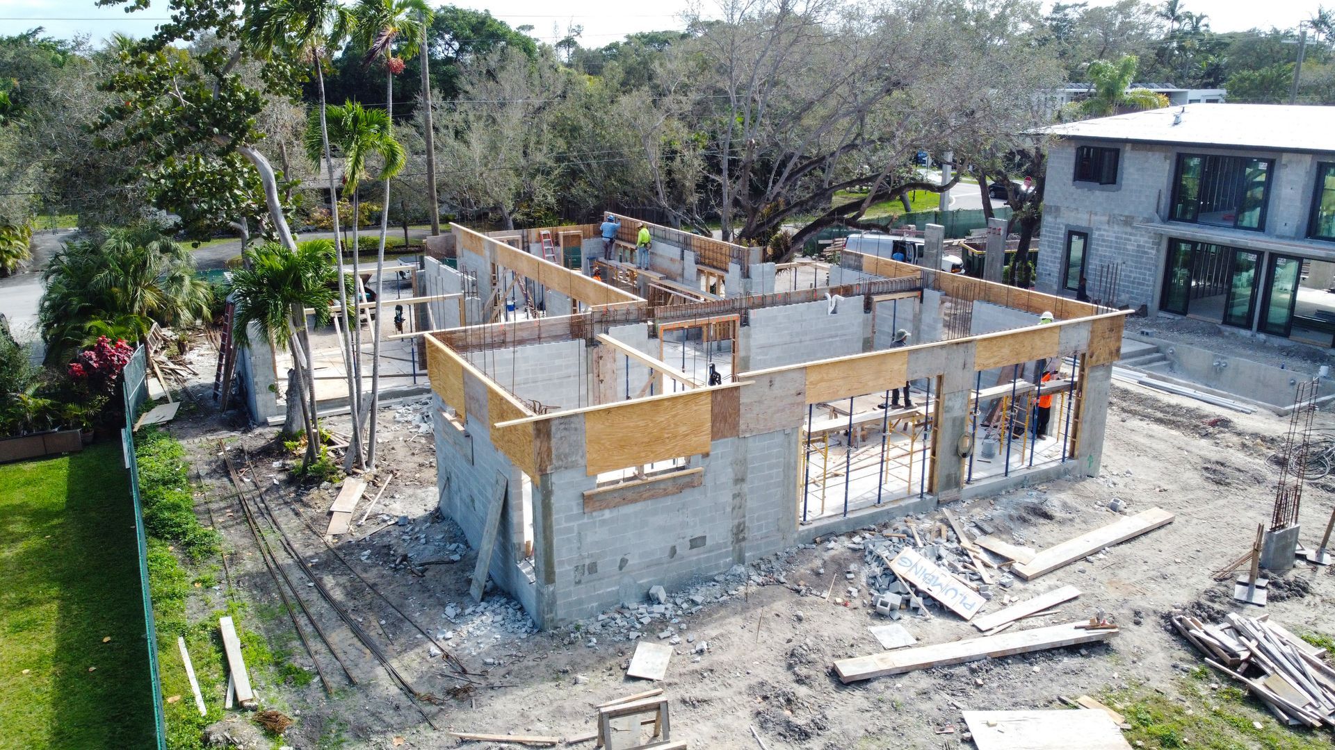 Construction site: concrete structure in progress, workers visible.