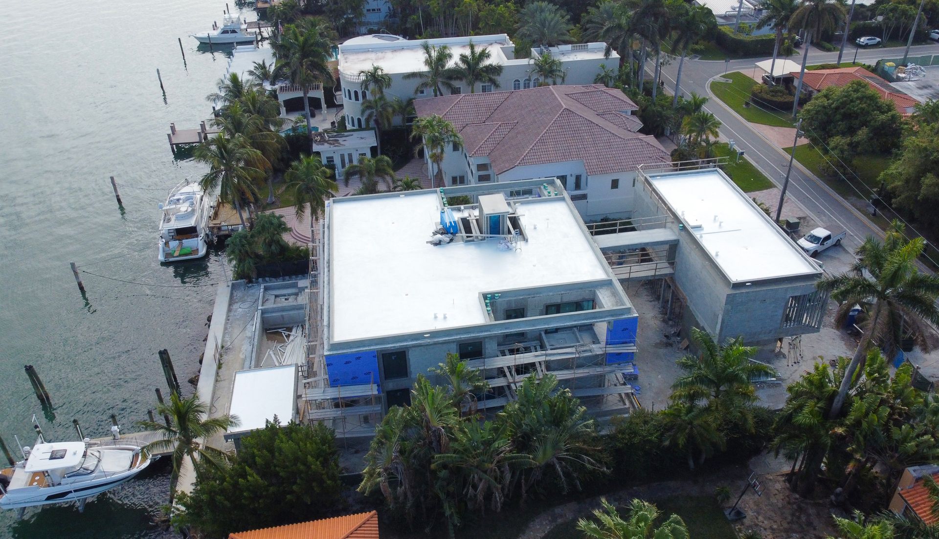 An aerial view of a building with a white roof