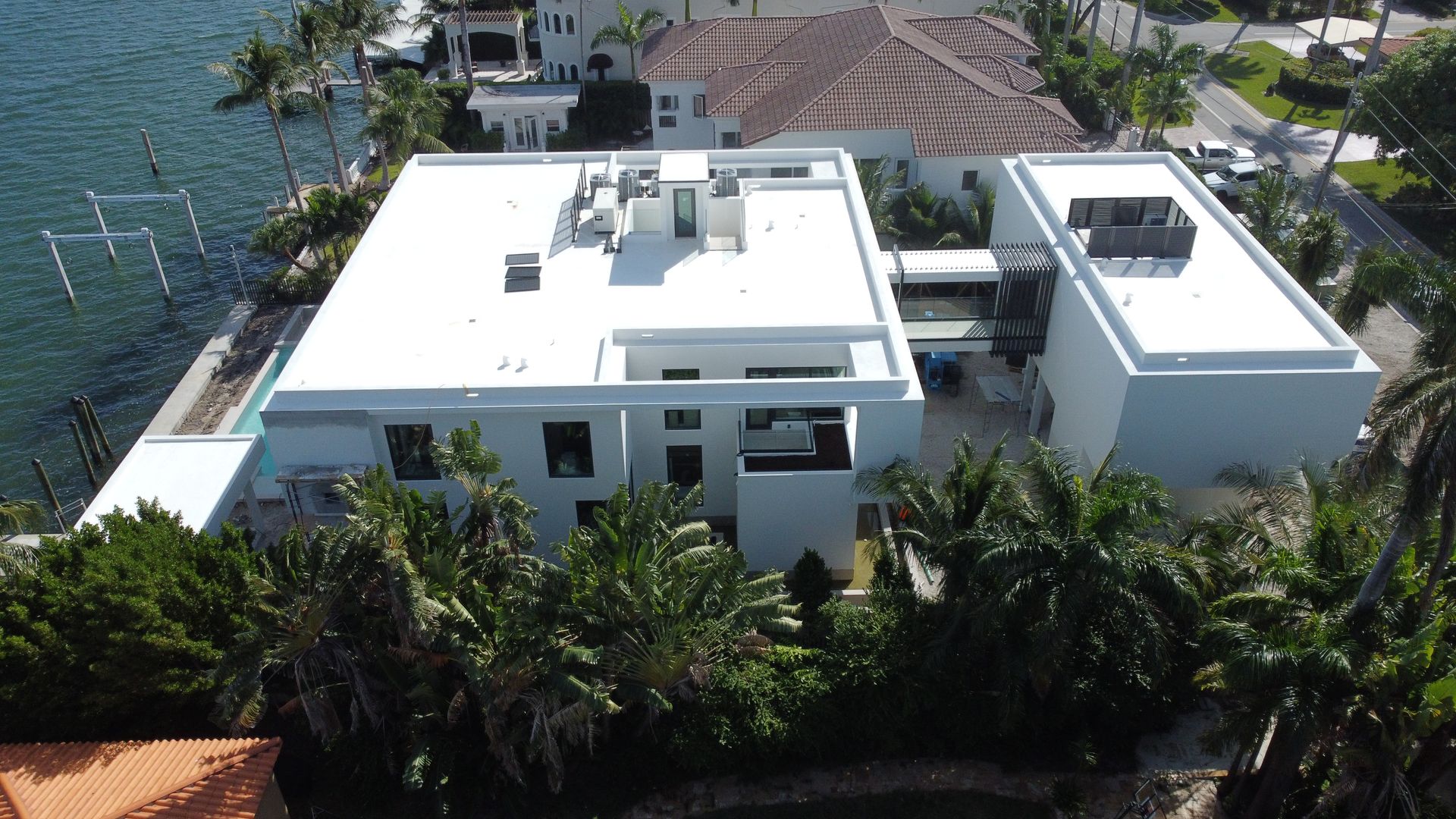 An aerial view of a house with a white roof