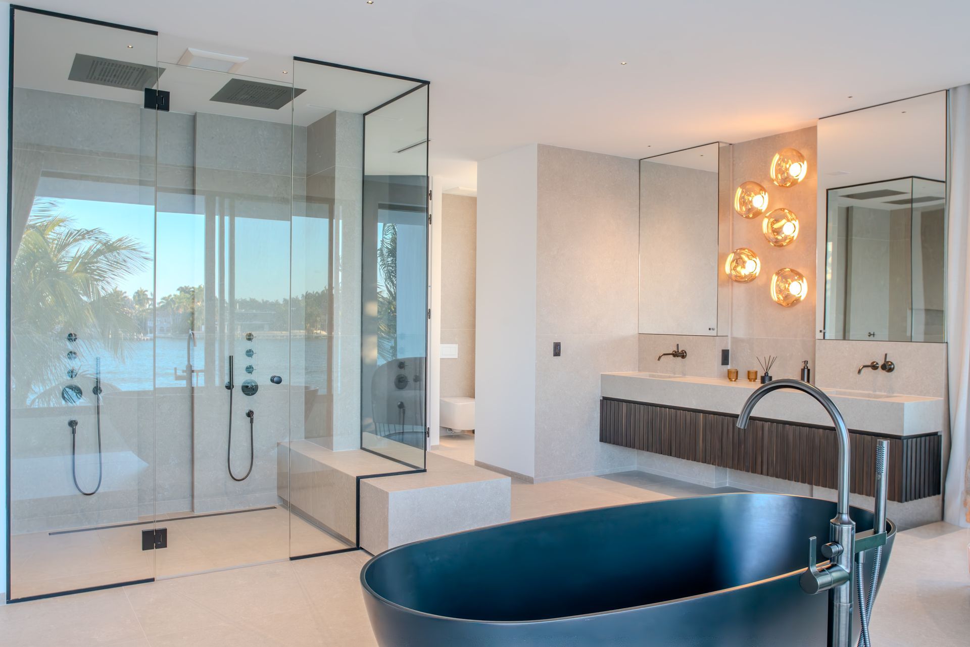 Luxurious modern bathroom with a black tub, large glass shower, and double vanity.