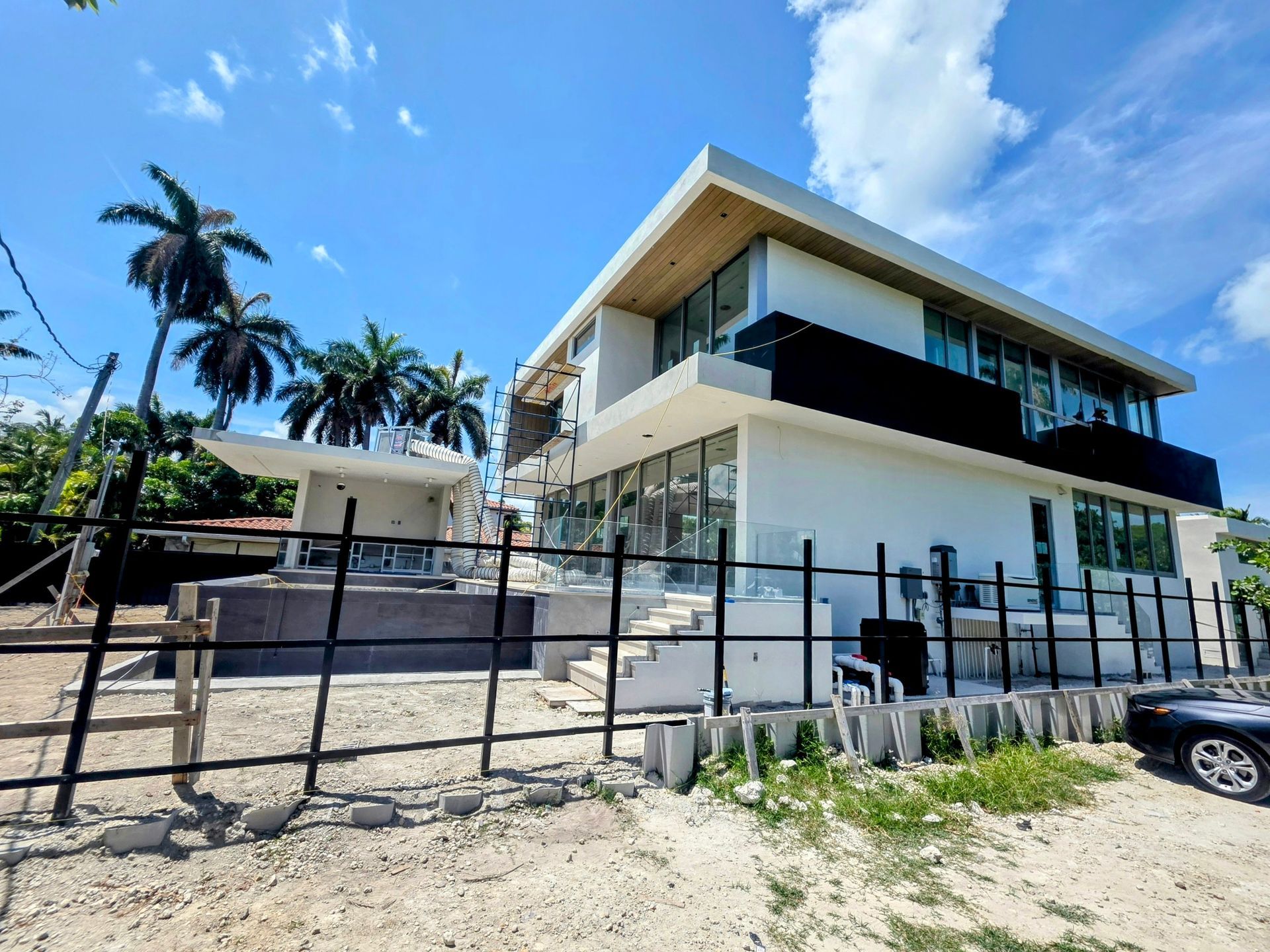 A large white house with a black fence around it