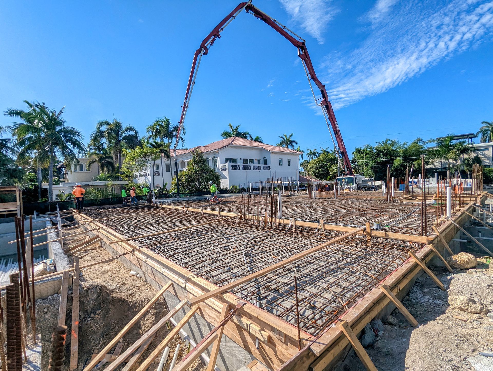 A concrete pump is being used to pour concrete on a construction site.