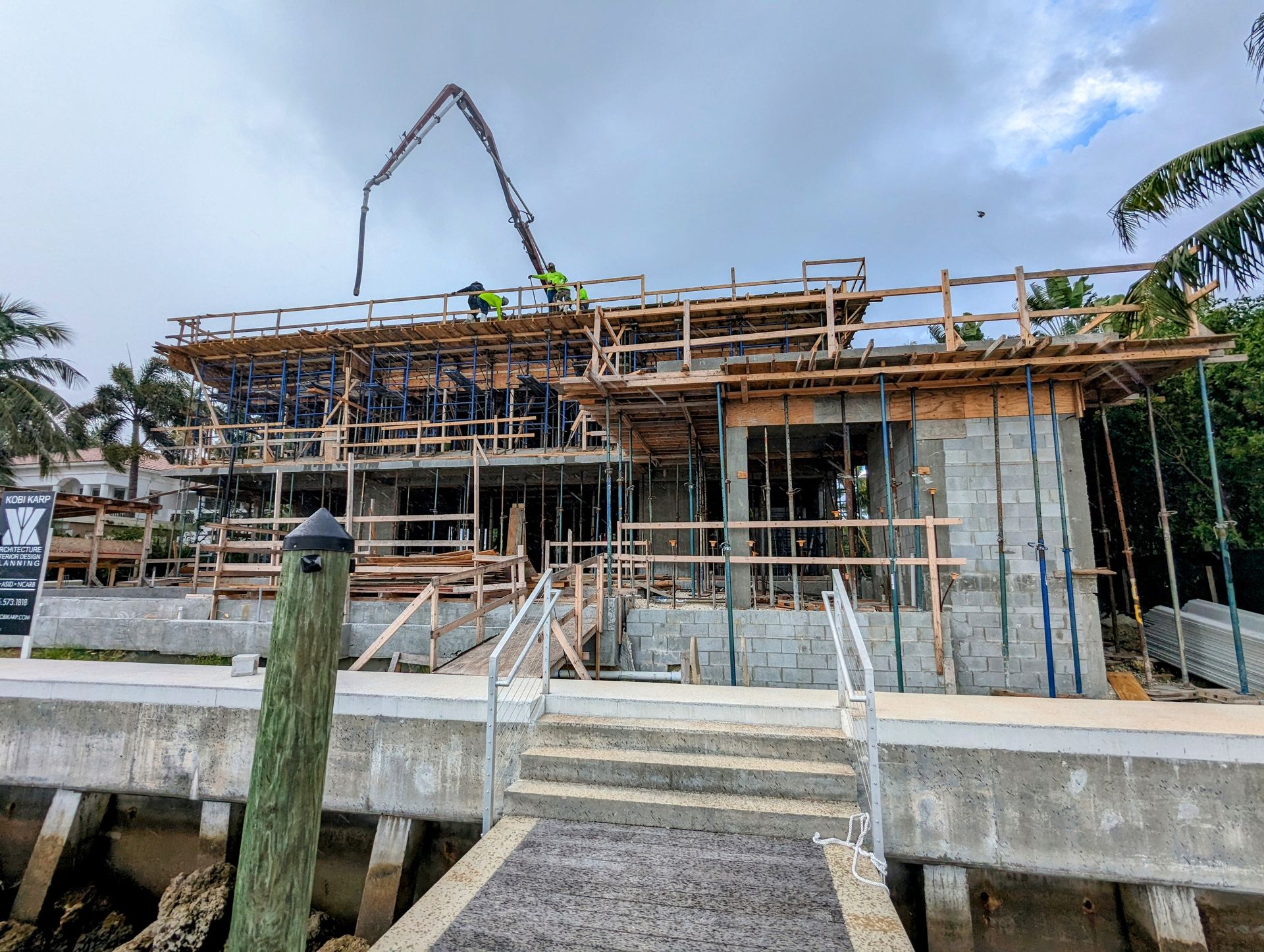 A large house is being built next to a dock.