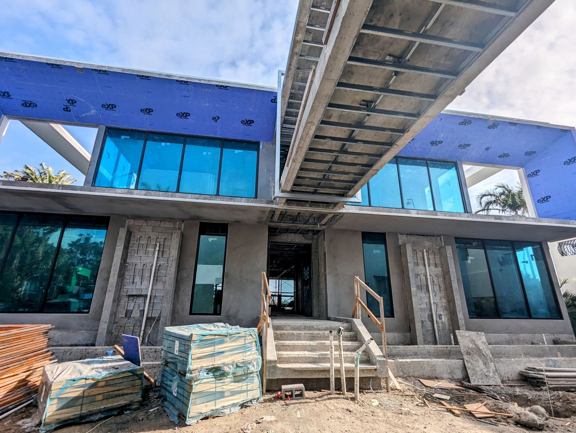 A large building under construction with a staircase leading up to it.