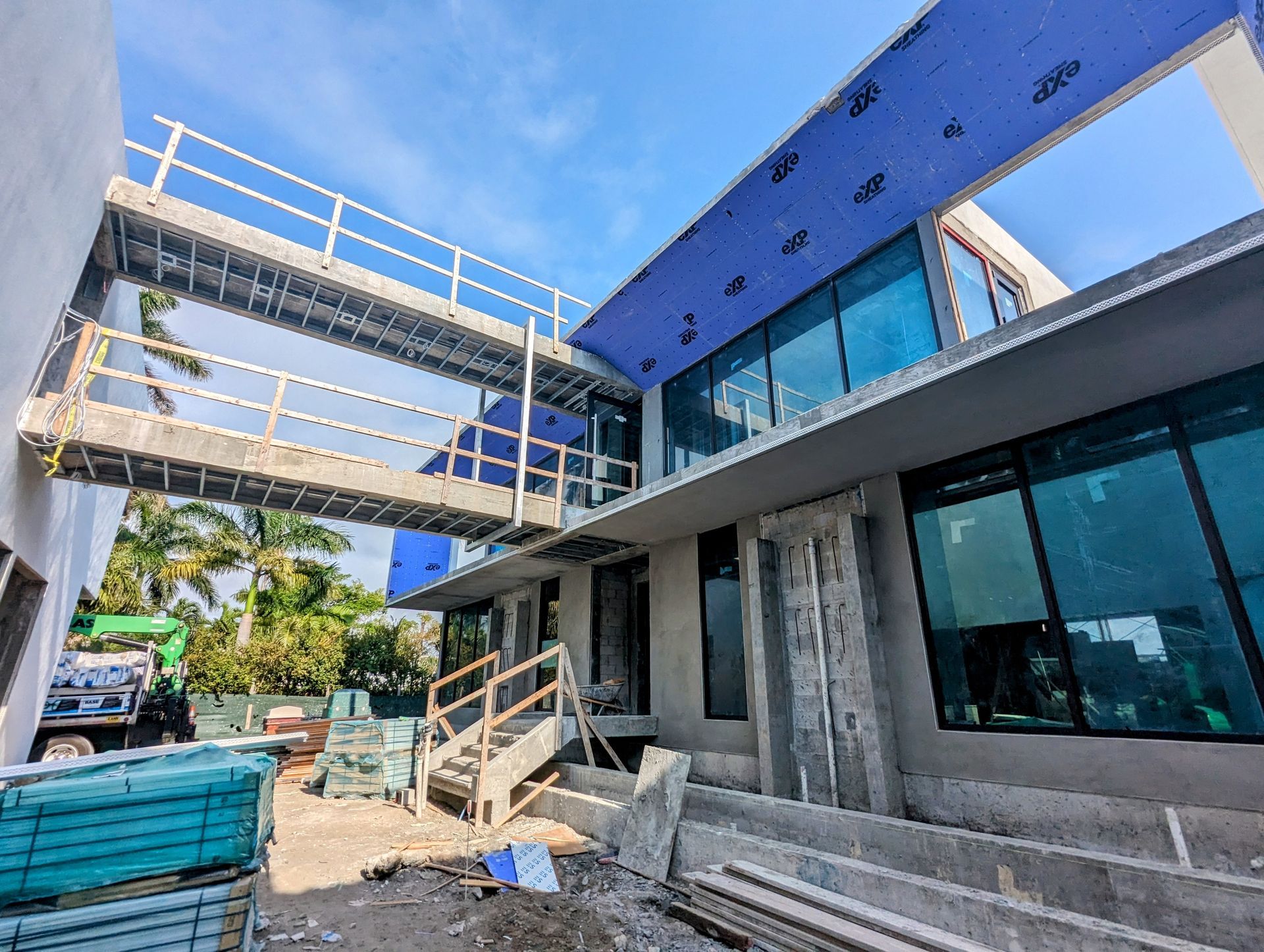 A building under construction with a bridge between two buildings.