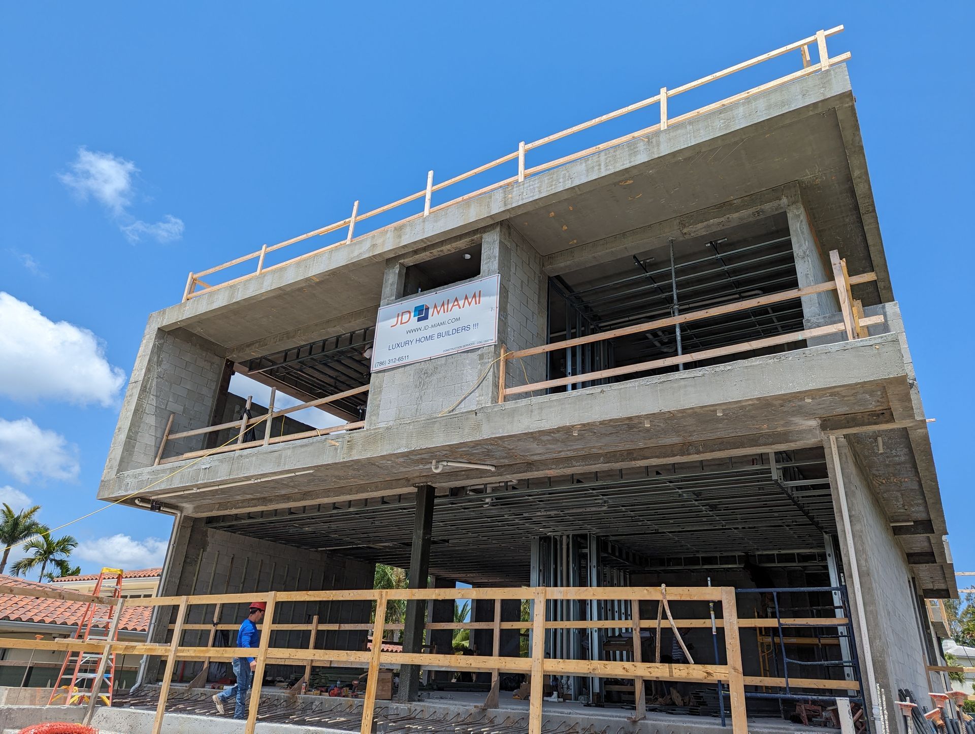 A large building under construction with a blue sky in the background.