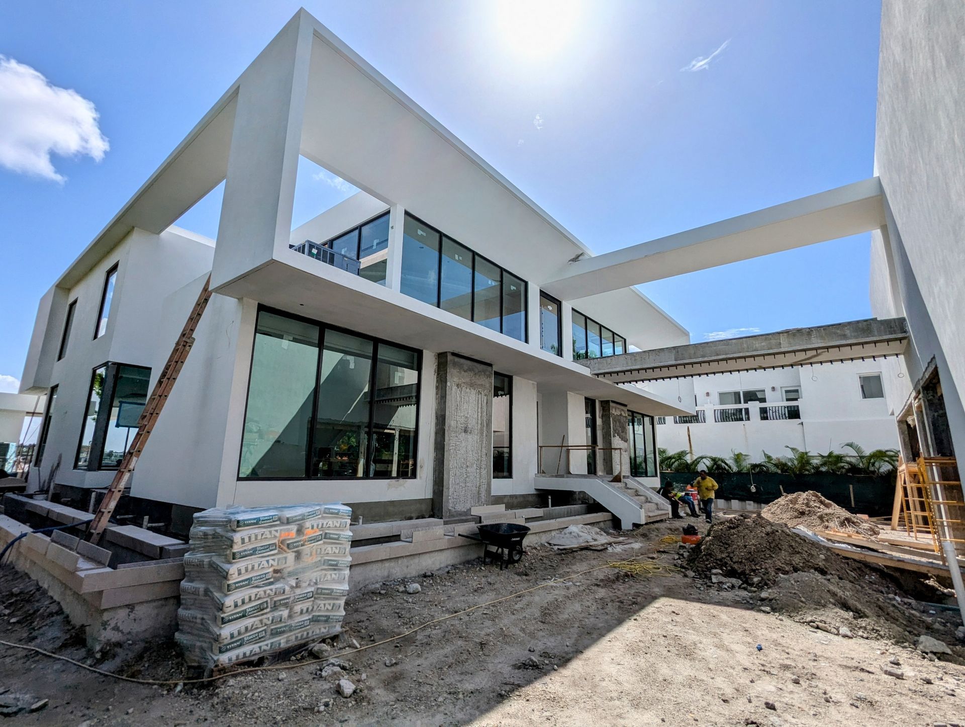 A large white house with a lot of windows is being built.