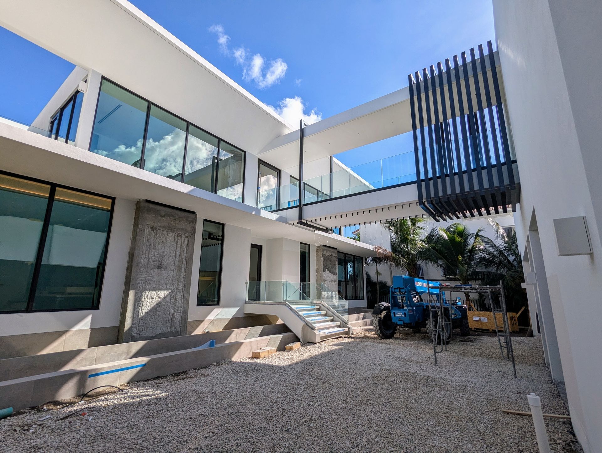 A large white house with a lot of windows is being built.